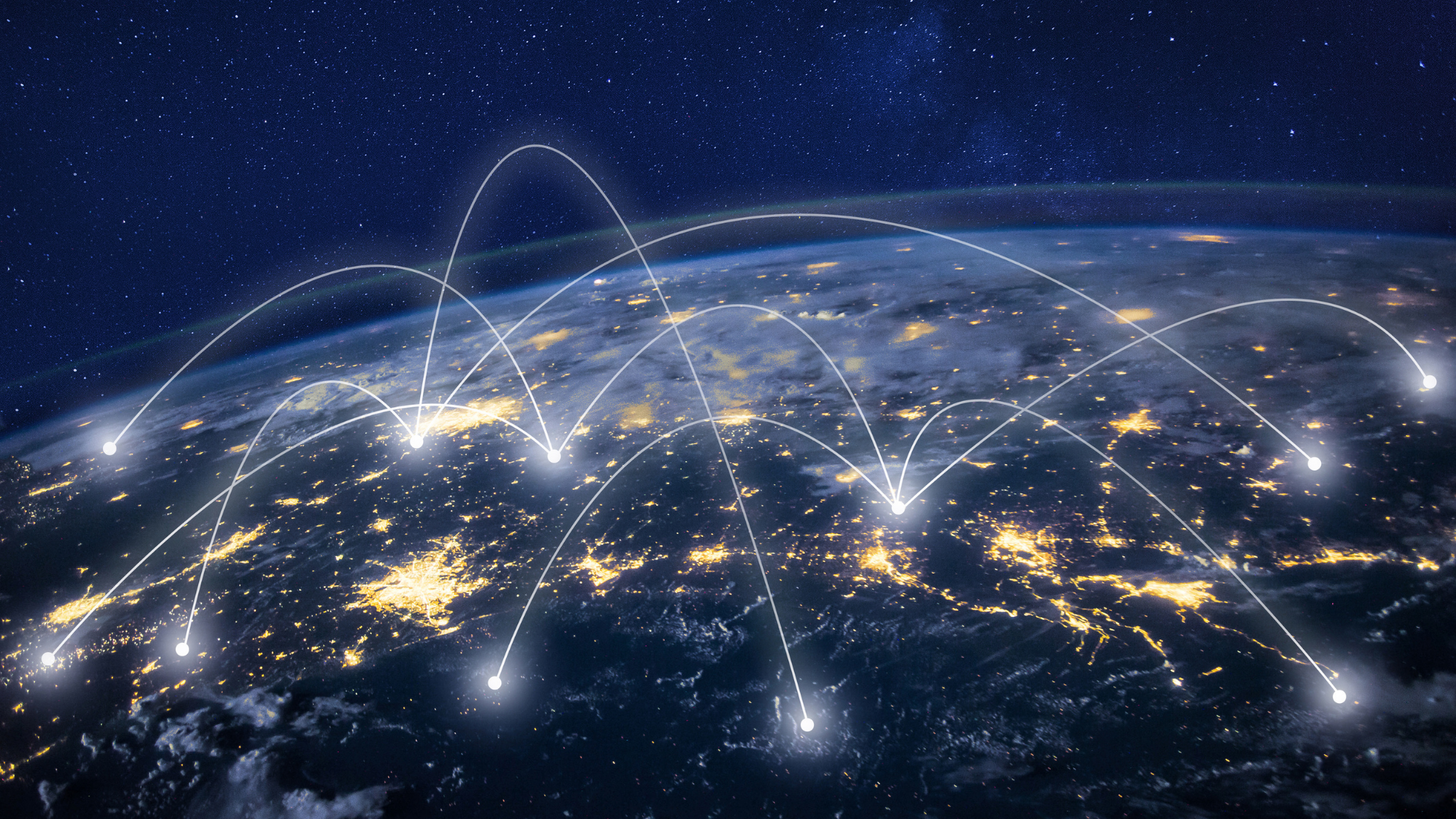 Nighttime view of Earth from space with illuminated cities and network lines connecting various locations across the globe.