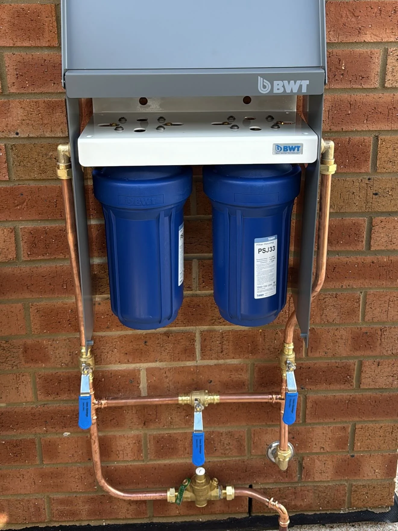 Professional installation of a whole-home water purification and filtration system by a licensed plumber.