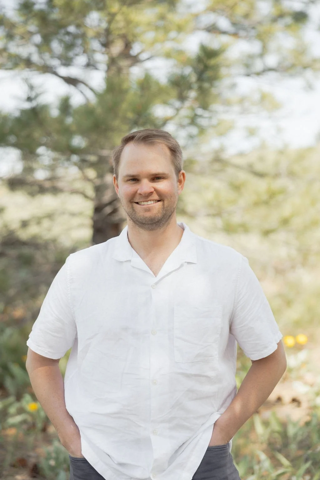 Mitch Gavin, Founder of HBE, in a white collared shirt in front of a tree