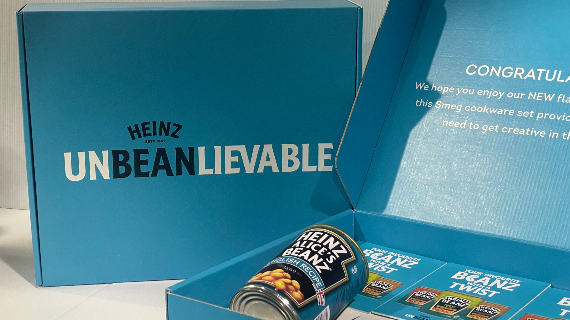 Malcove nz special project customised branding and product packaging for FMCG campaigns with Heinz. Blue box labeled Heinz Unbeanlievable with a can of Heinz baked beans