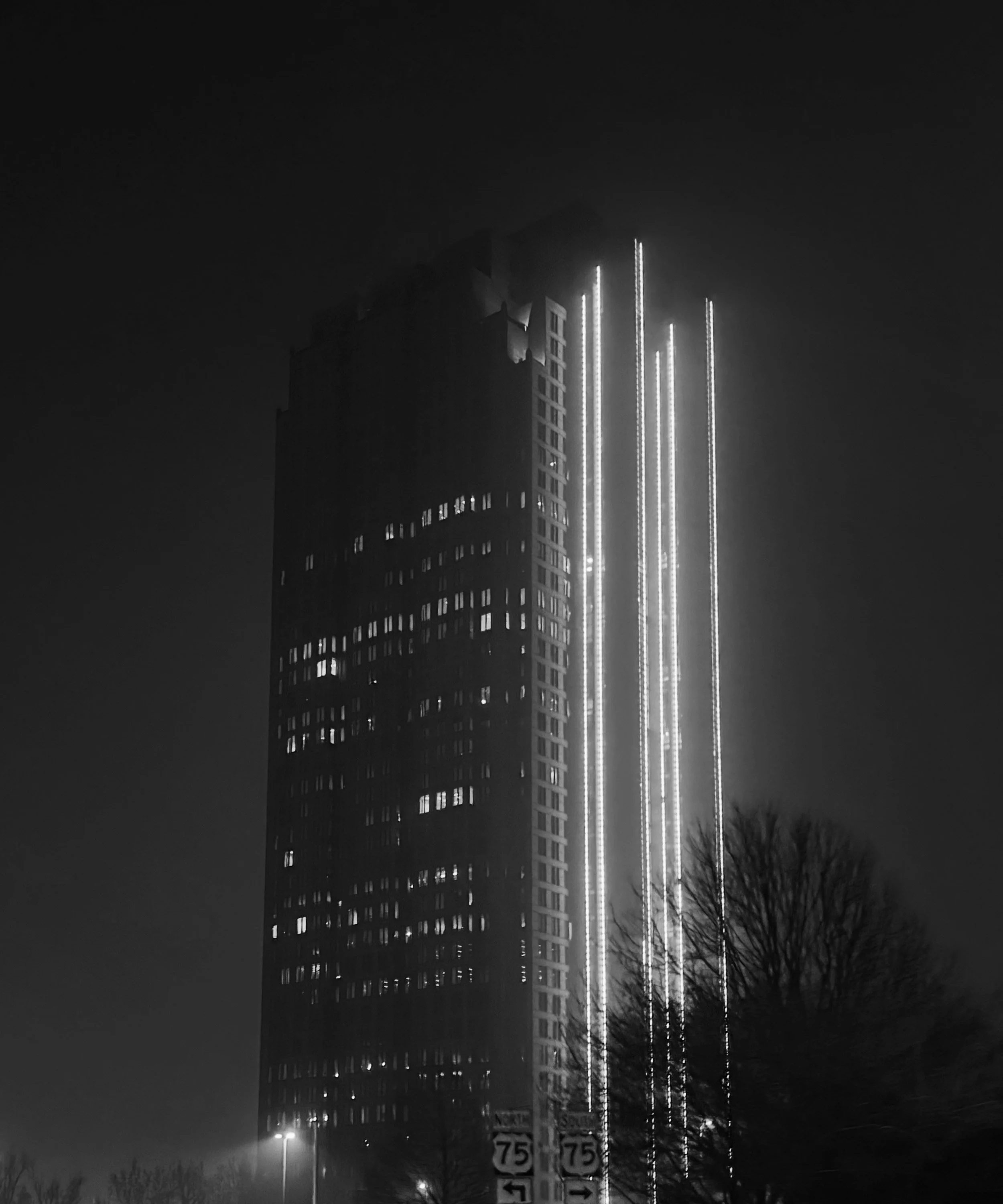 Building in Dallas Texas on highway 75 at night in black and white
