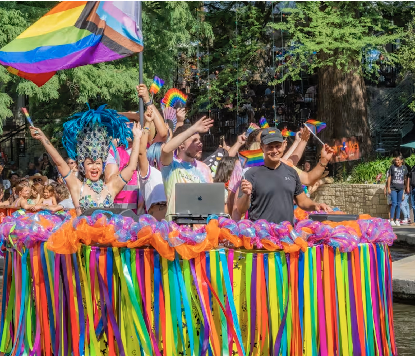 Float with drag performers and rainbow decorations at the Visit San Antonio Pride River Parade celebrating San Antonio Pride and LGBTQ+ community visibility.