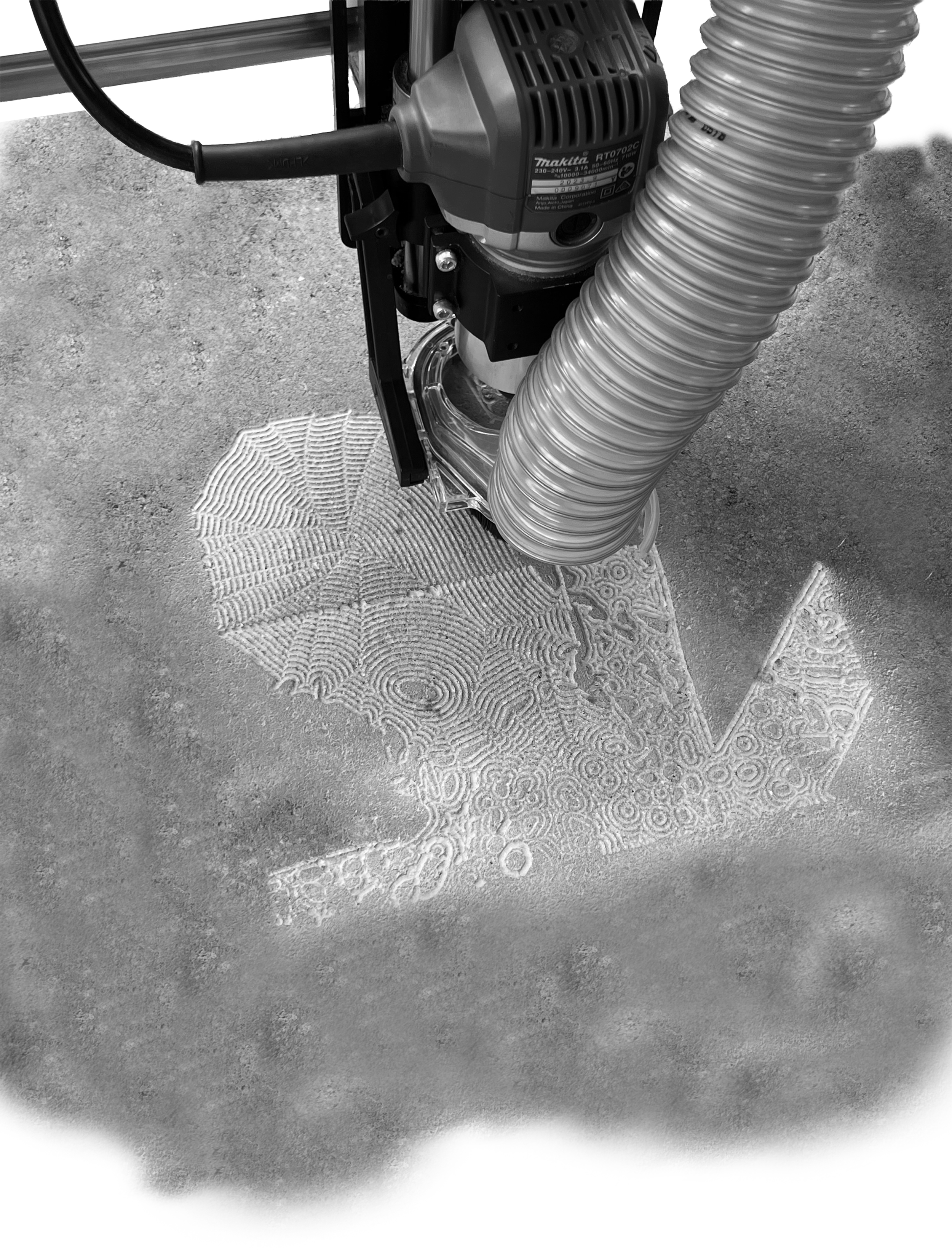A CNC machine creating a detailed line art design in the sand.
