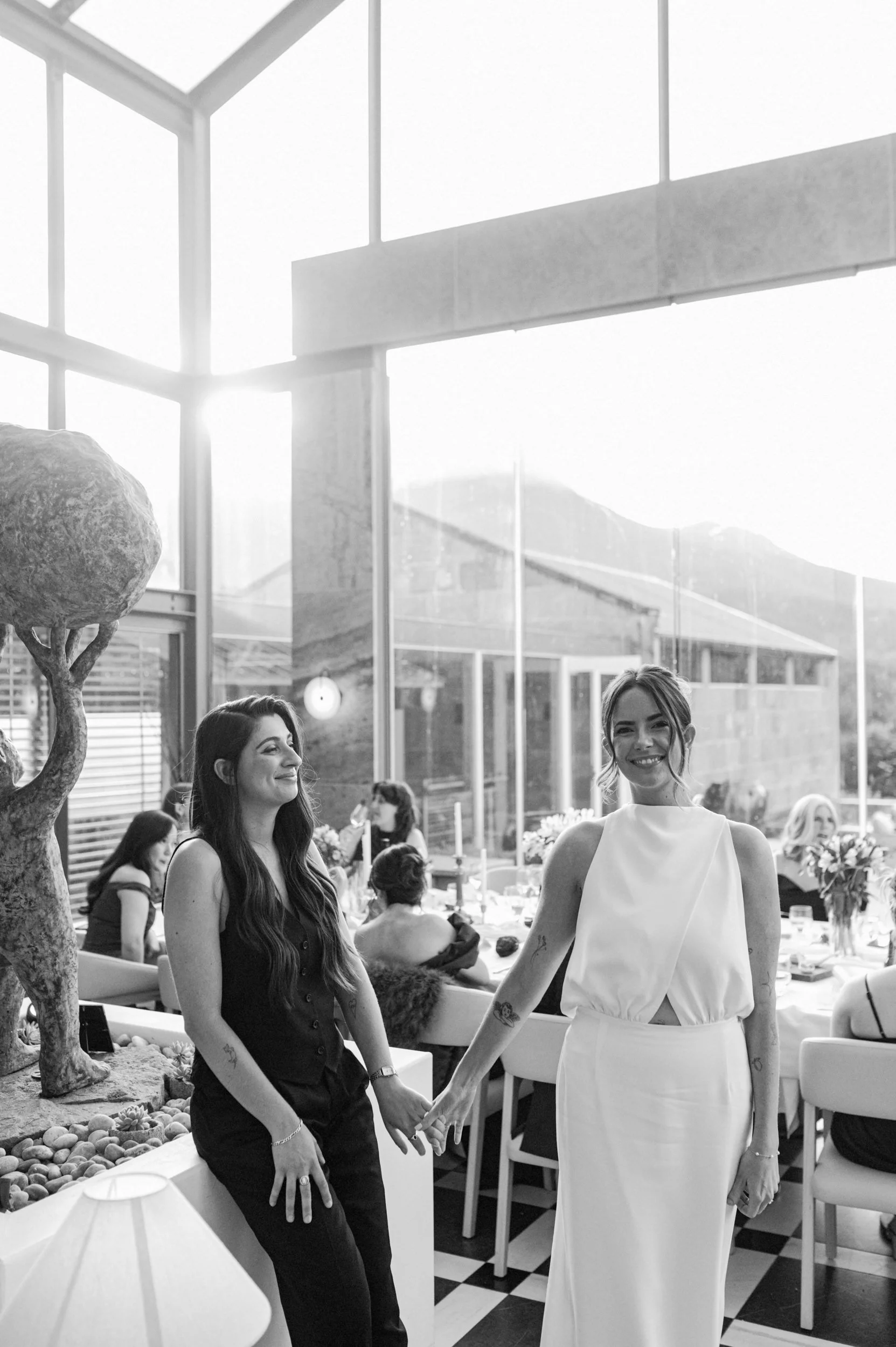Two women holding hands at a wedding reception at The Islington Hotel, Hobart, Tasmania
