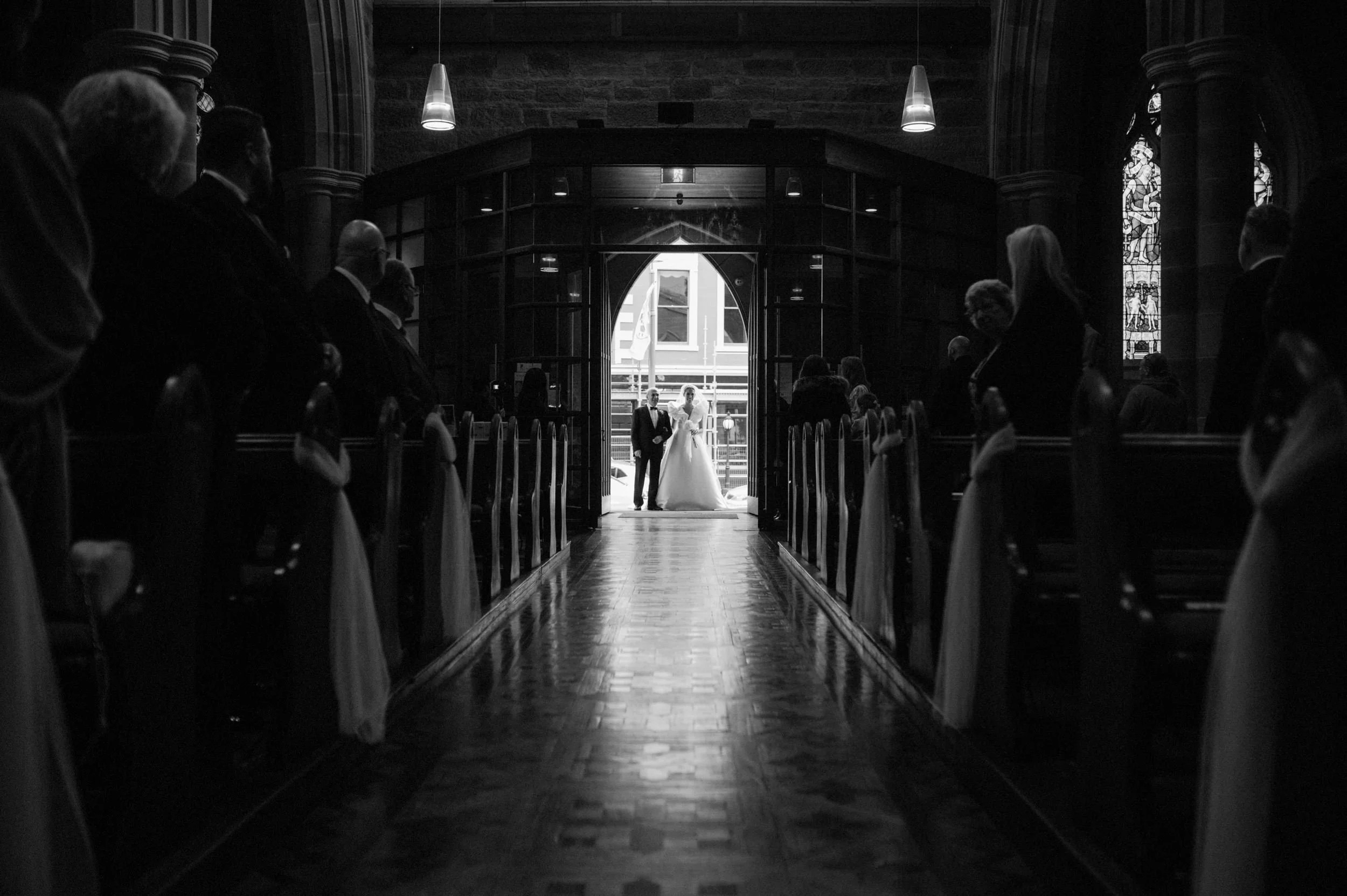 A bride enters St. Davids Cathedral in Hobart, Tasmania