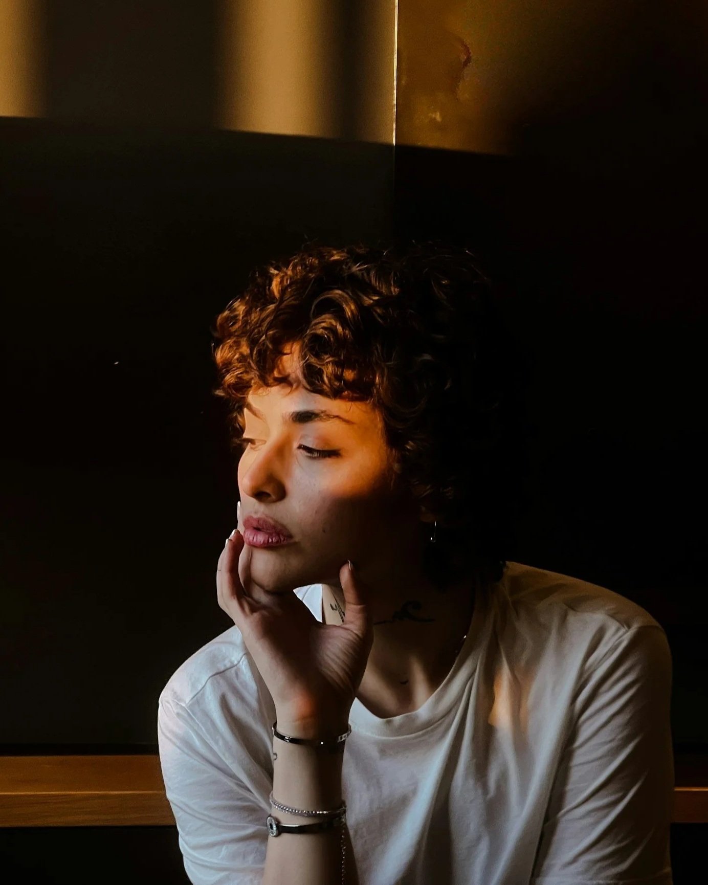 Person in a reflective moment representing emotional heaviness, stress, and internal overwhelm.