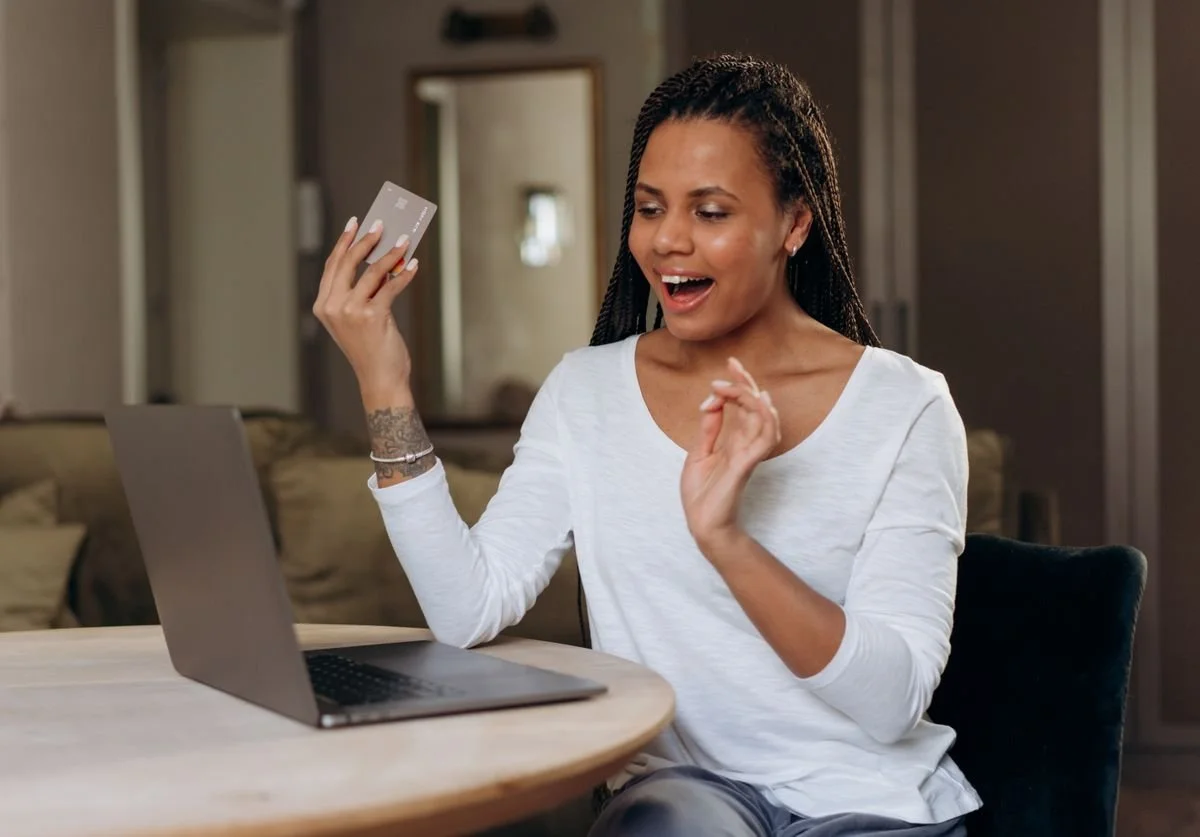 a-woman-that-is-happy-make-a-booking-on-her-laptop-nomadic-virtual-solutions.jpg