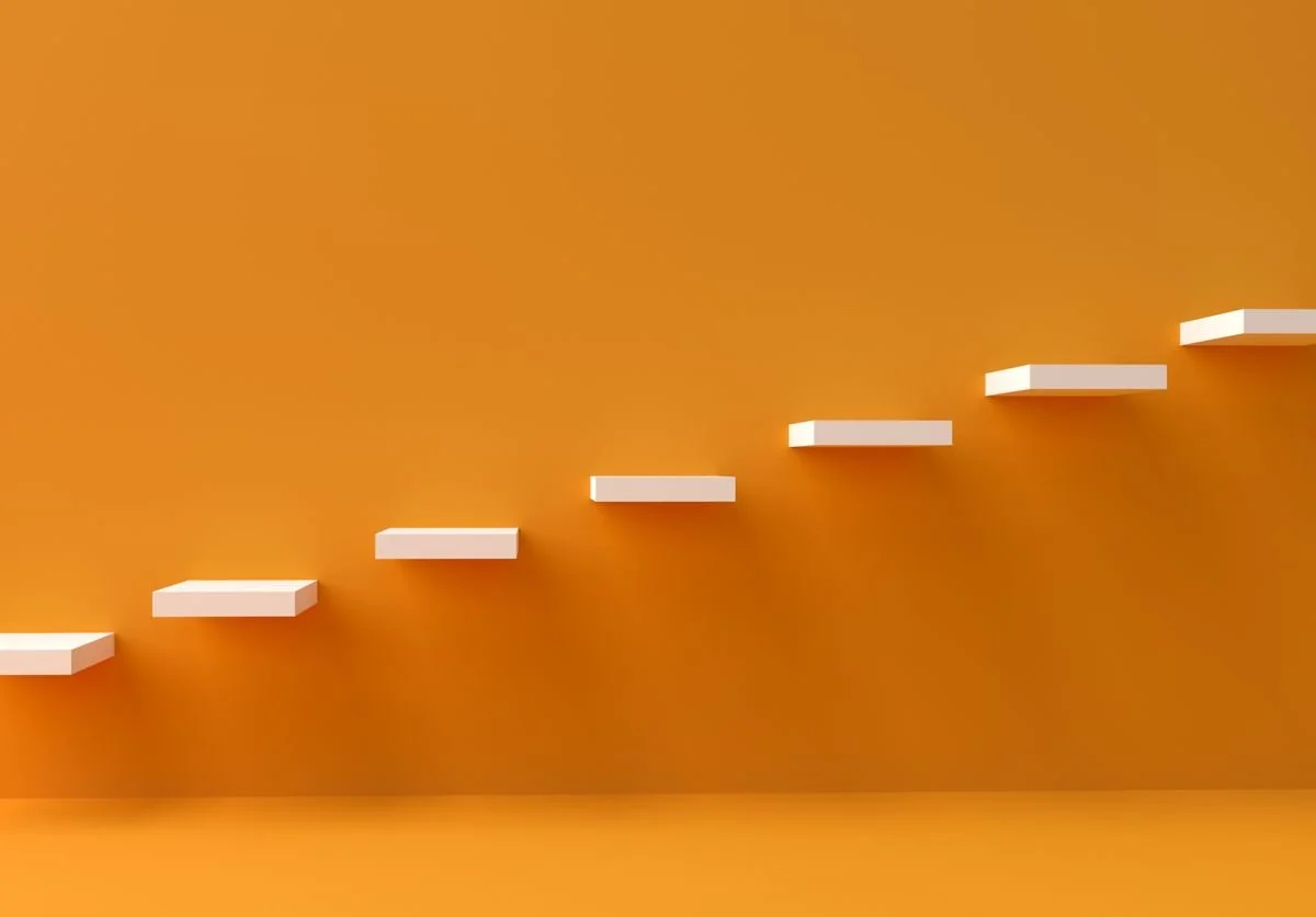 an-orange-wall-with-white-steps-that-symobilize-the-next-steps.jpg