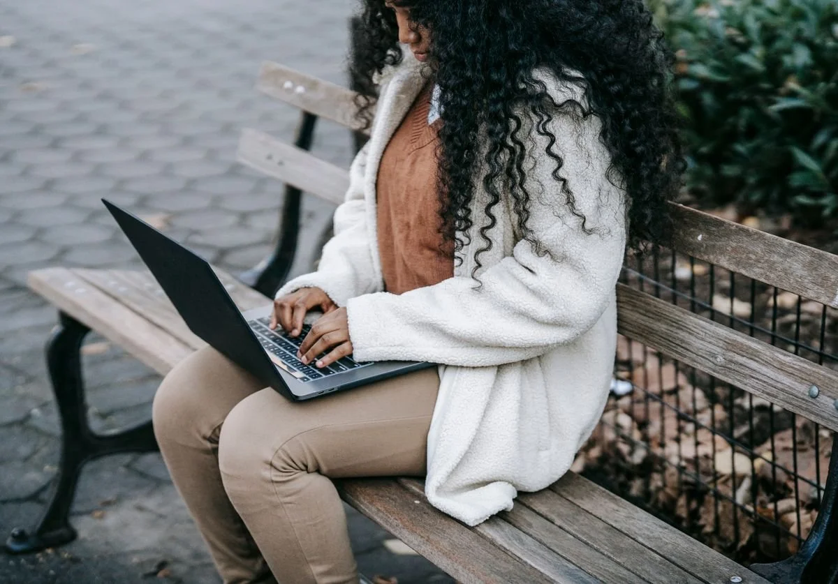 woman-using-laptop-on-bench.jpg