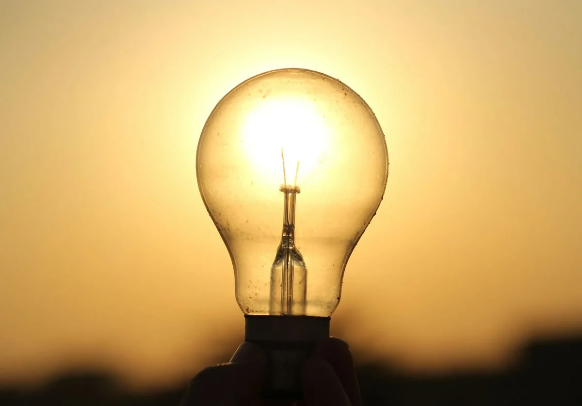 a-light-bulb-with-a-hazy-yellow-background-in-front-of-the-sun.jpg
