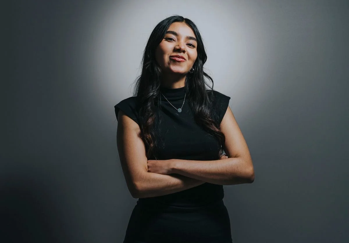 woman-in-black-dress-smiling-for-headshot-profile-picture.jpg