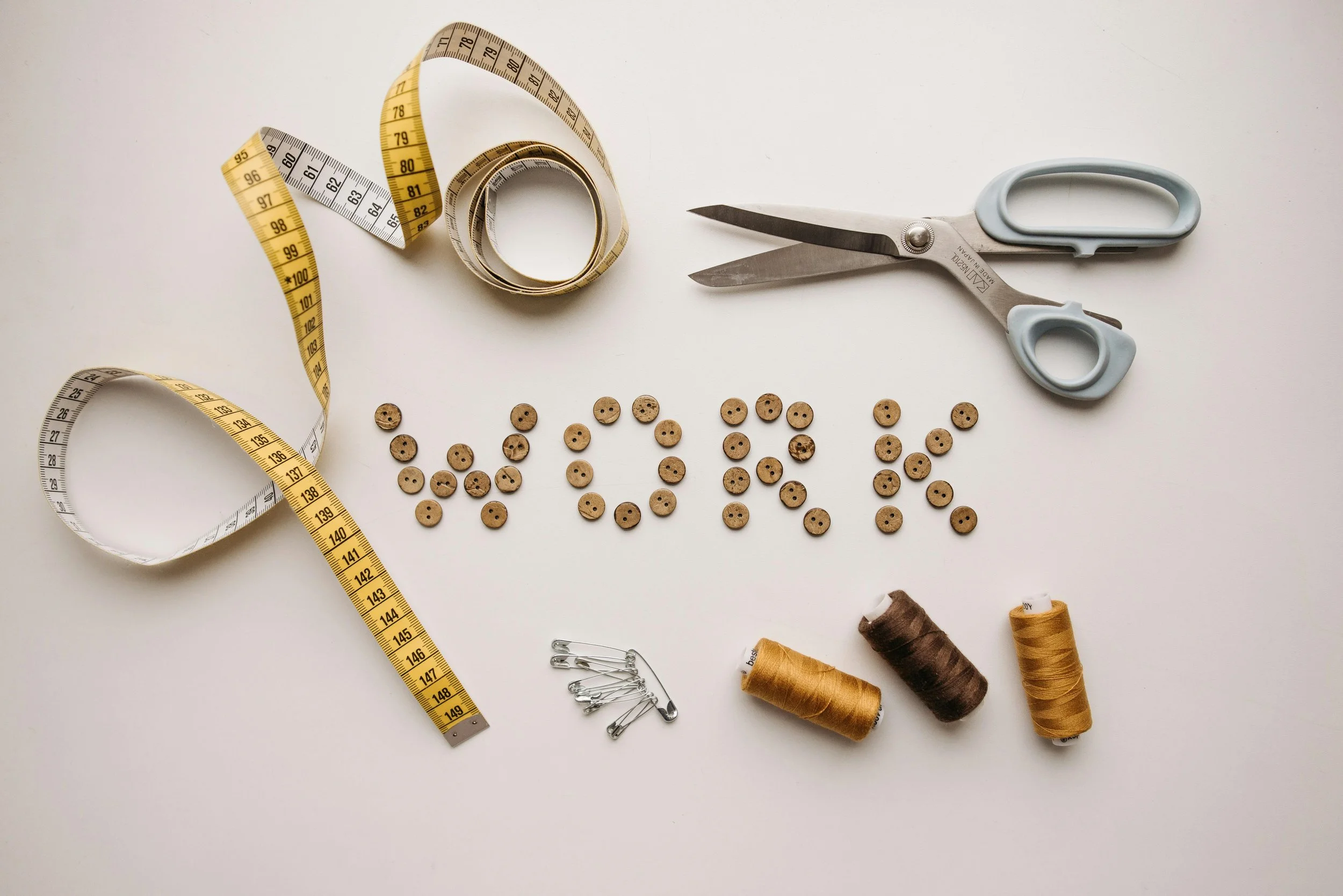 scissors-yarn-measuring-tape-and-the-word-work-spelled-out.jpg