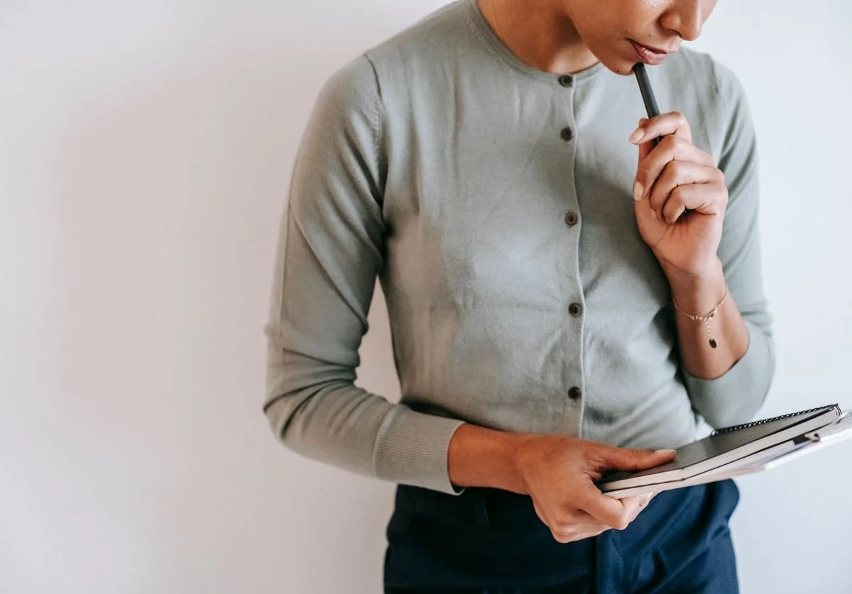 woman-looking-down-and-thinking-at-tablet.jpg