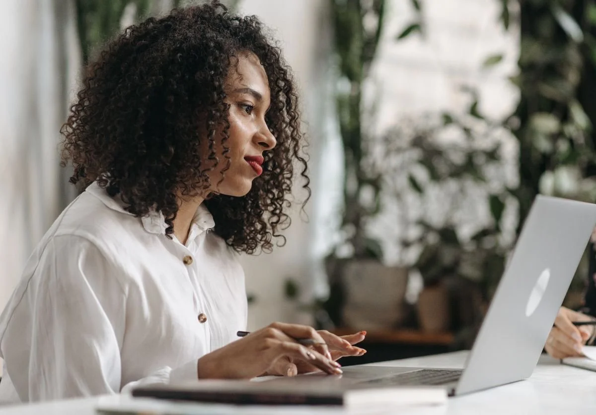 woman-looking-at-laptop-as-she-thinks-of-hiring-a-website-designer-for-custom-squarespace-site.jpg