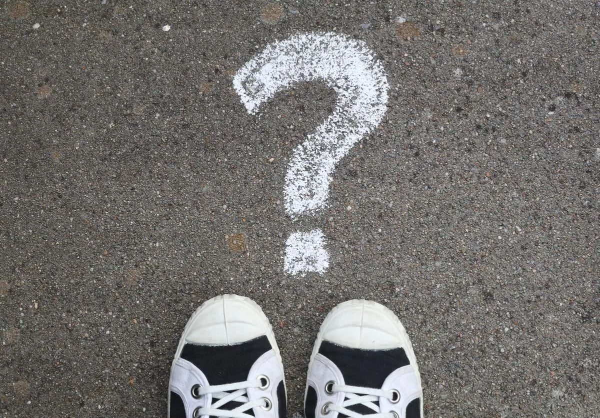 sneakers-on-the-ground-next-to-a-question-mark.jpg