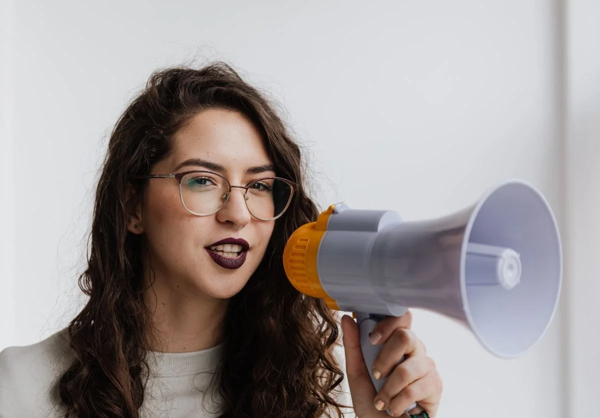 a-woman-speaking-on-a-loud-speaker.jpg