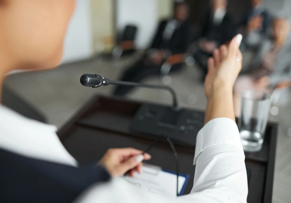 woman-speaking-on-podium-to-crowd.jpg