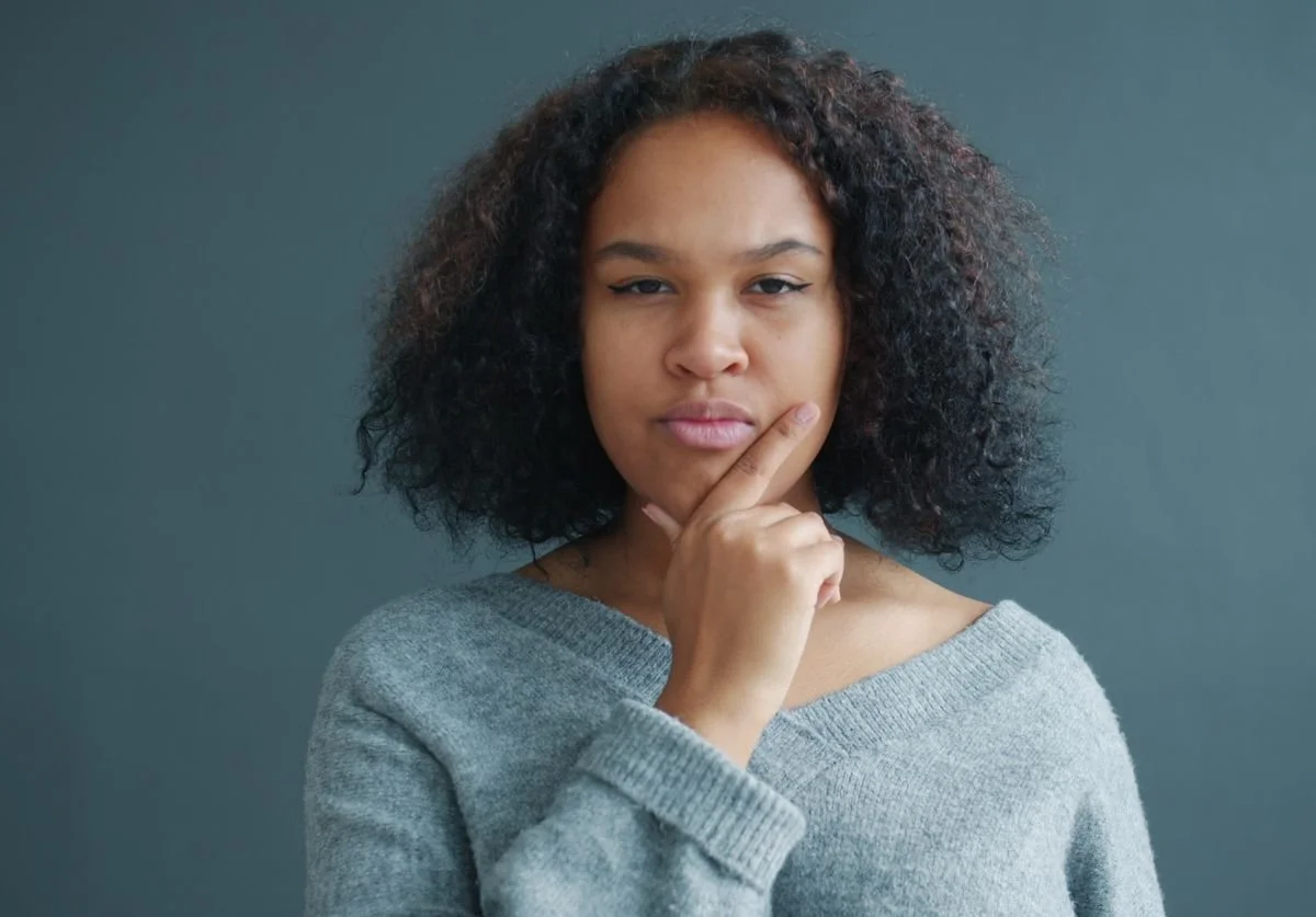 woman-thinking-about-landing-page-vs-website.jpg