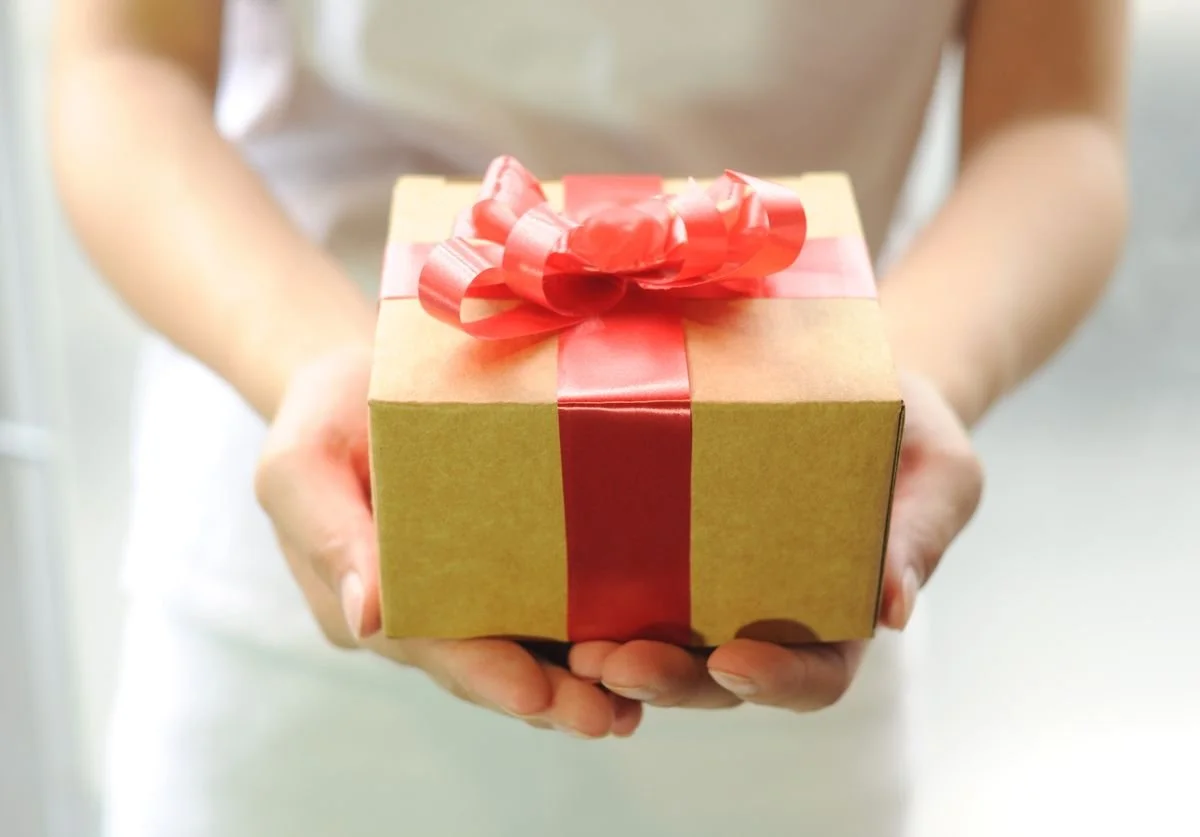 a-woman-holding-a-suprise-box.jpg