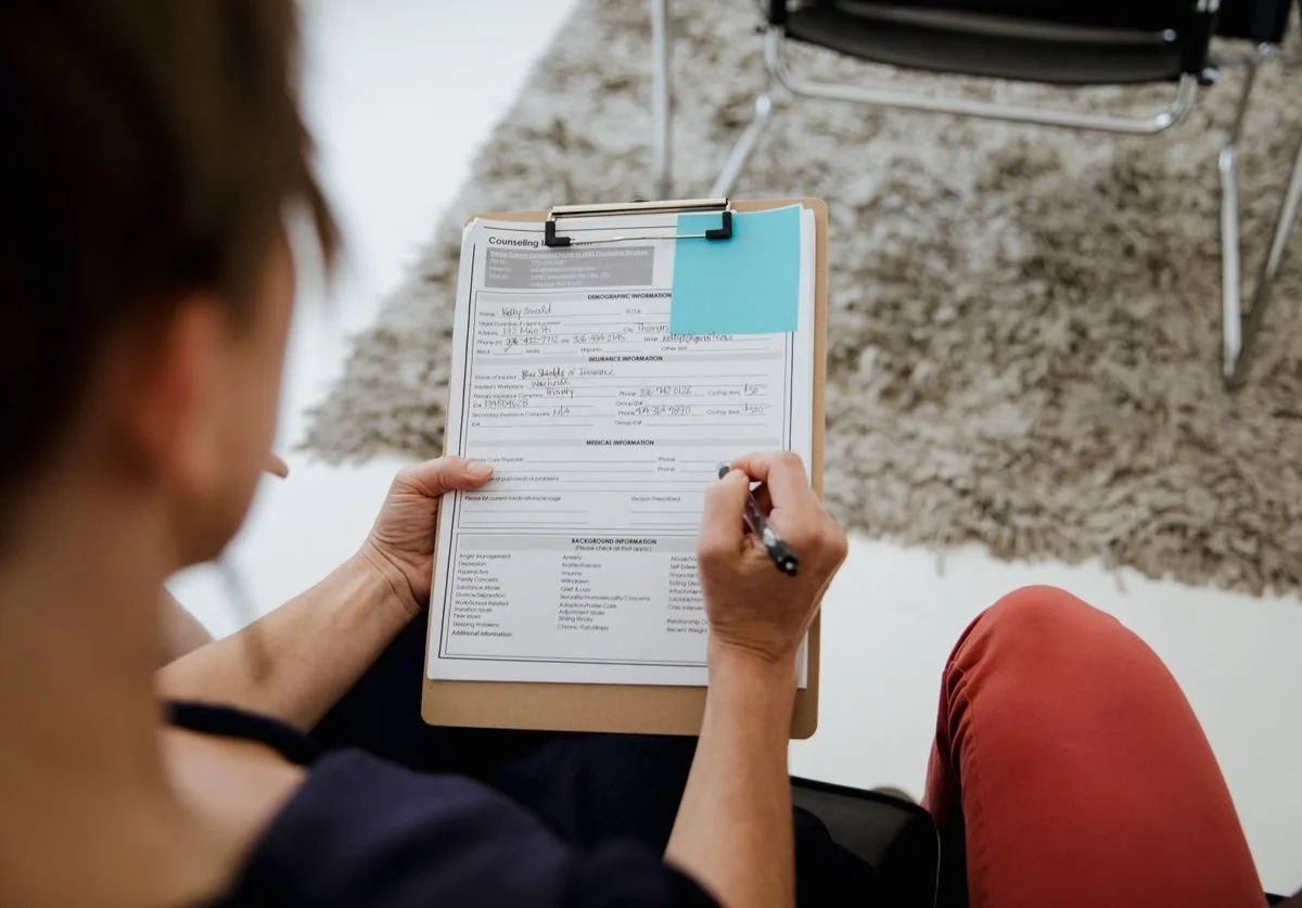 a-woman-filling-out-a-booking-form.jpg