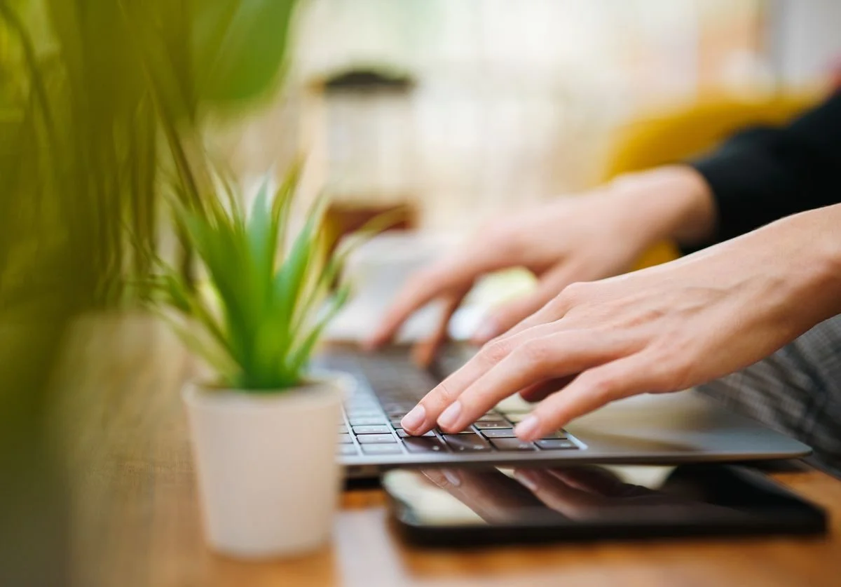 woman-typing-on-a-computer-wellness-website.jpg