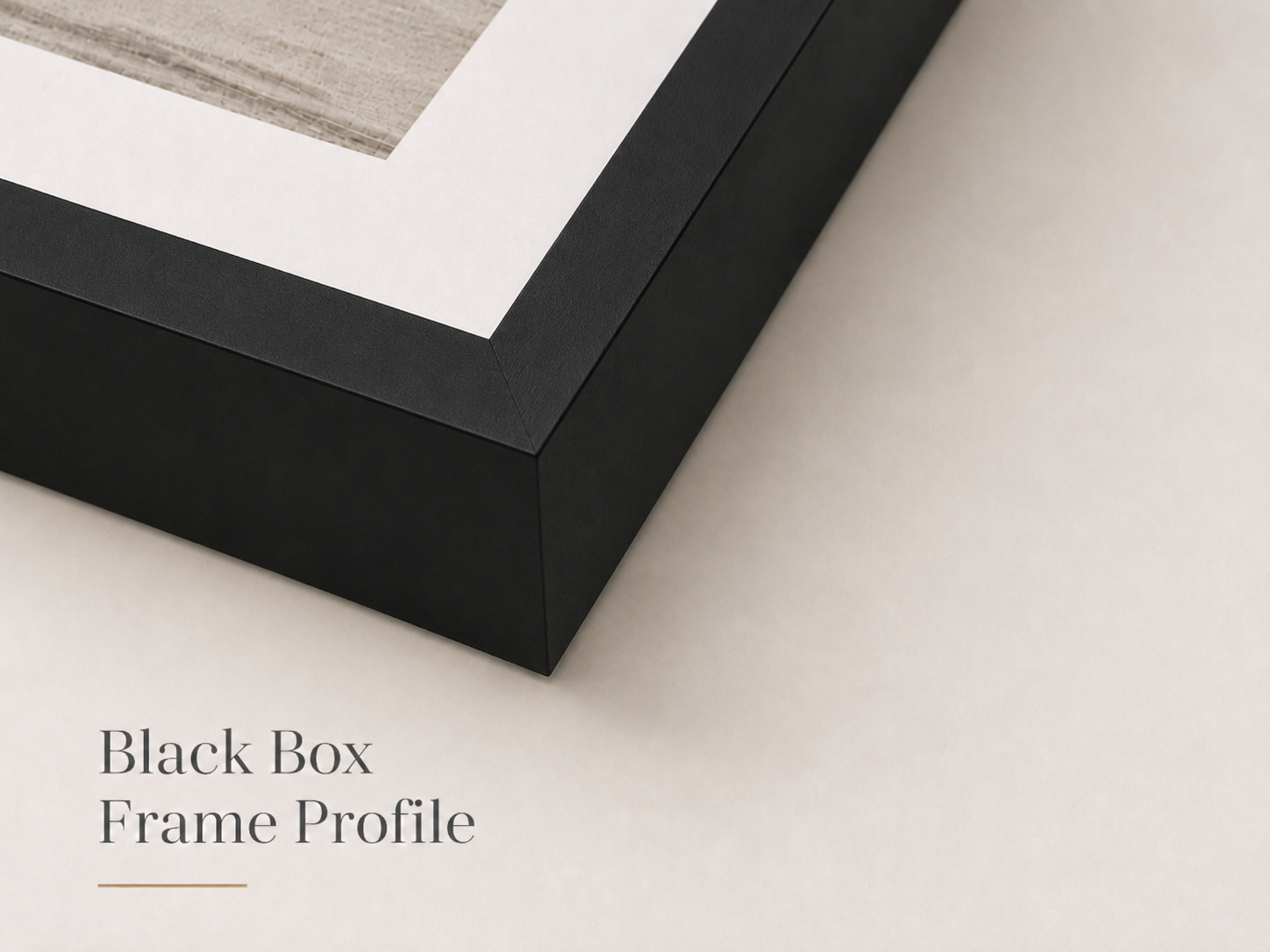 Close-up of a black picture frame with a photograph inside, placed on a light-colored surface. The photo appears to be an architectural or interior image.