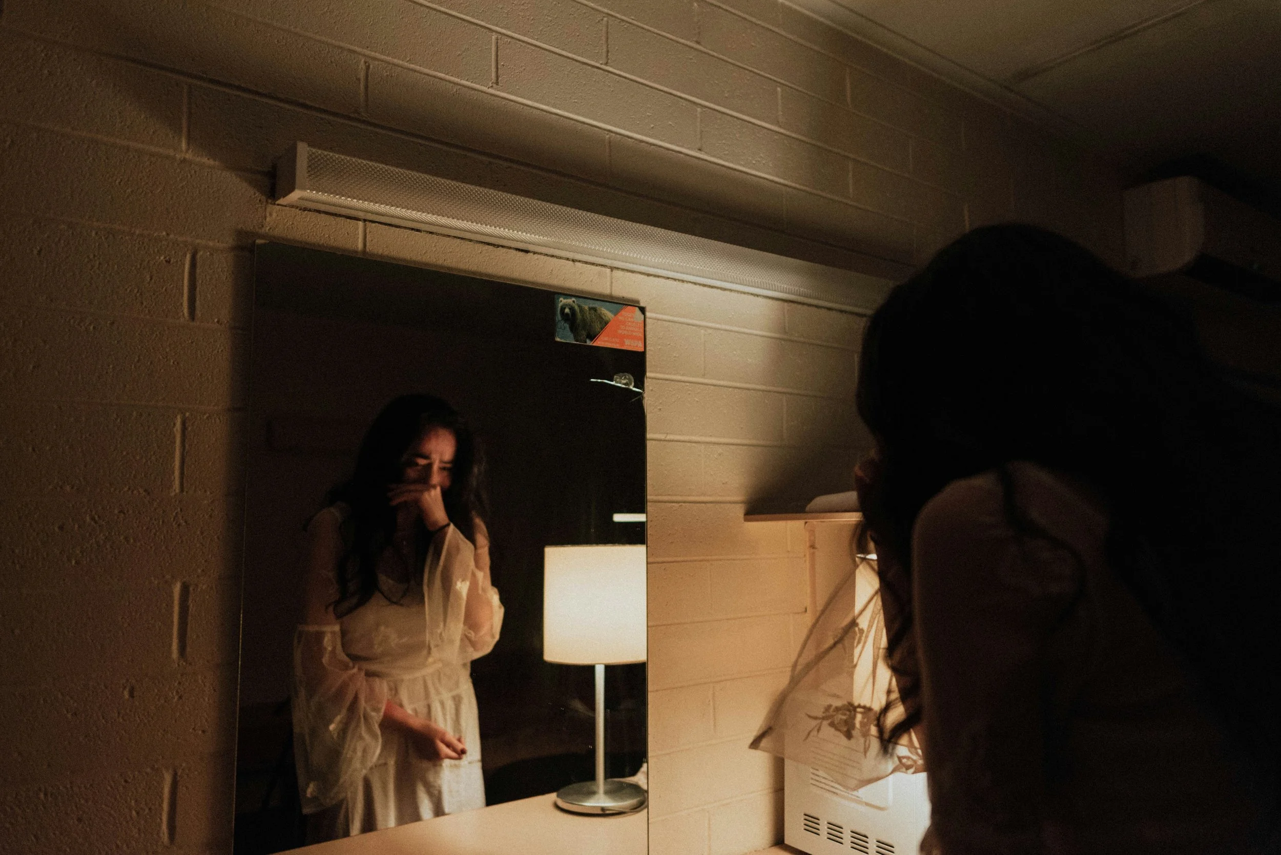 sad woman crying, looking in mirror