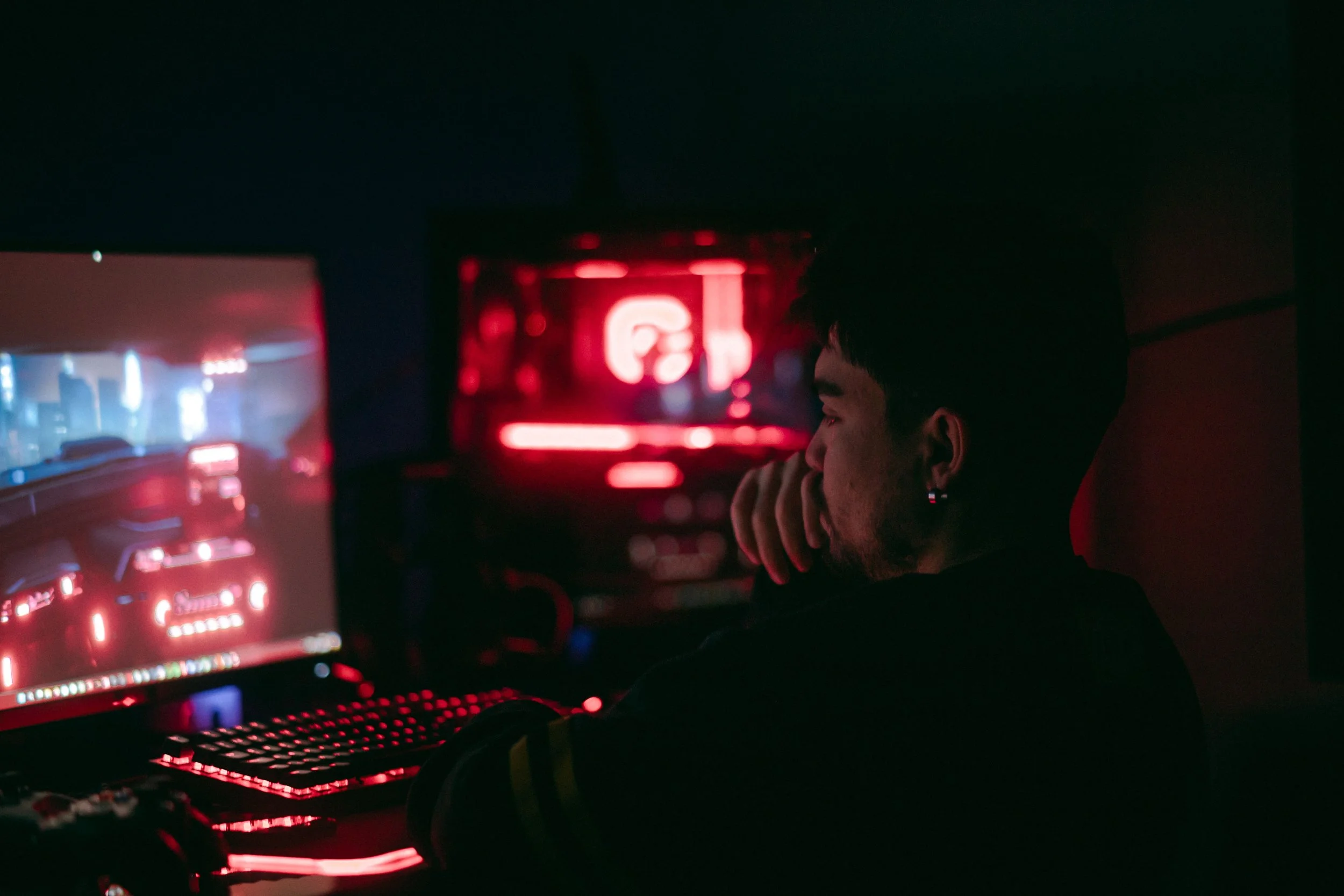 student playing video game at night, looking tired