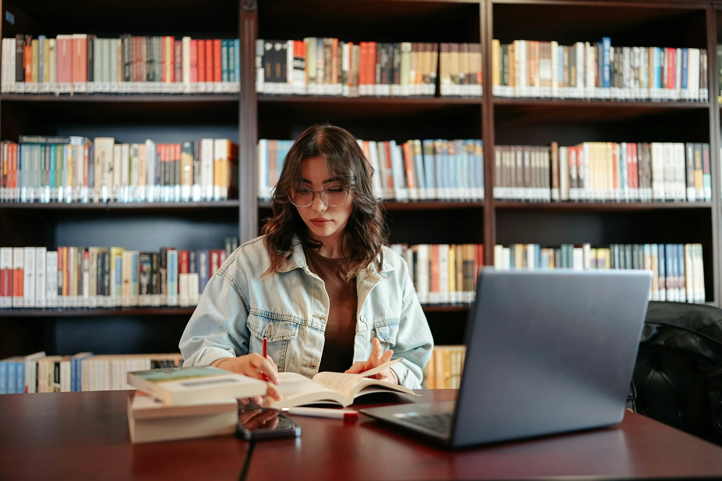 first-generation college student studying alone looking determined but quietly overwhelmed