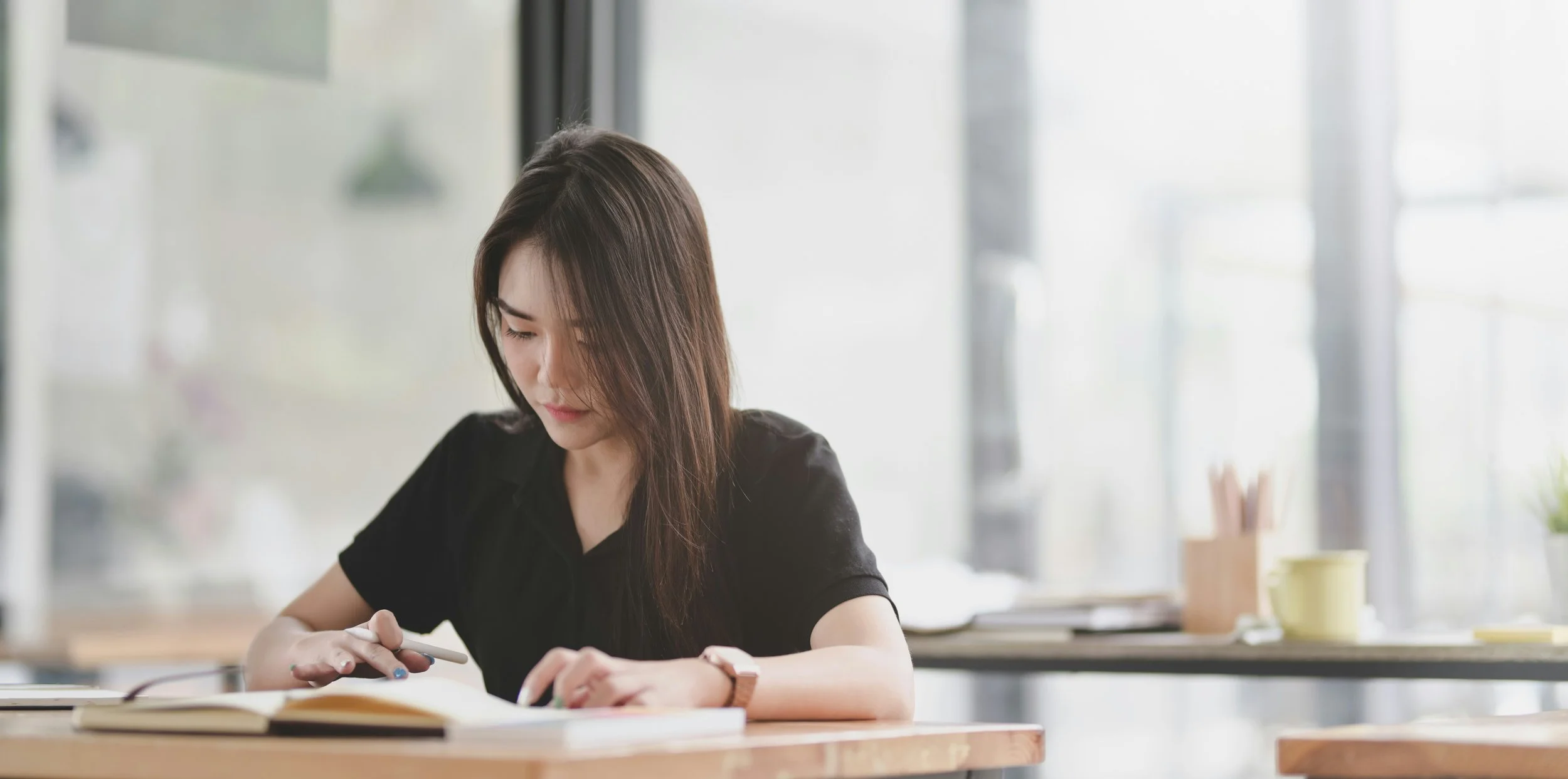 student taking notes, looking focused and calm