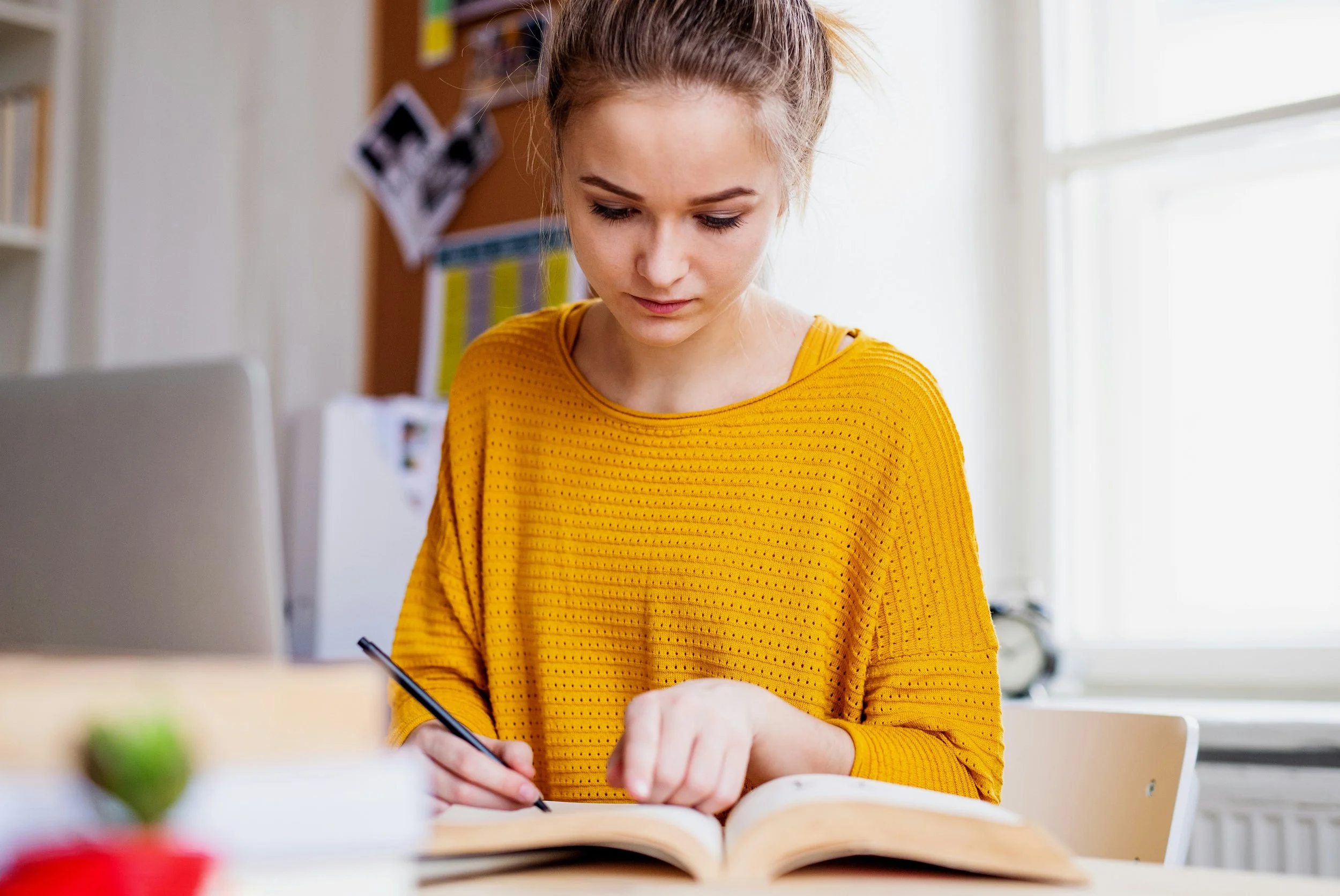 college student smiling on the outside but visibly tense on the inside