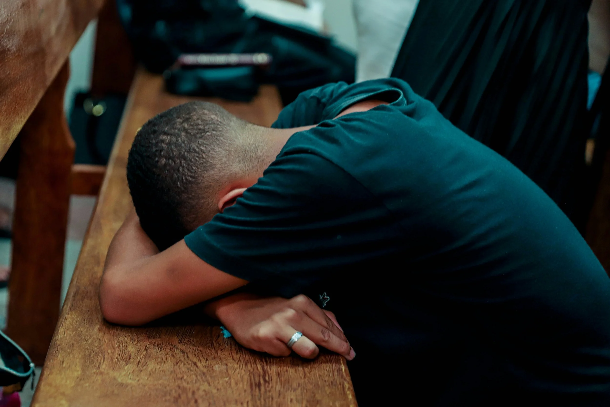 stressed college student with his head down on desk