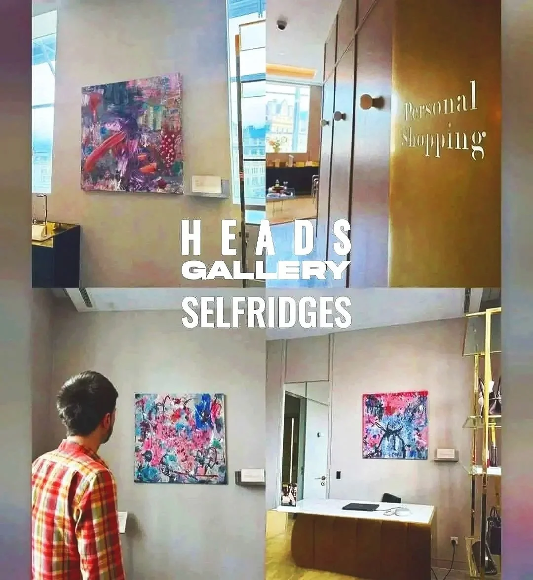 Interior of an art gallery with abstract paintings on walls, a person with dark hair and a red plaid shirt observing art, and a reception desk in the background, with words overlayed mentioning 'Heads Gallery', 'Personal Shopping', and 'Selfridges'.