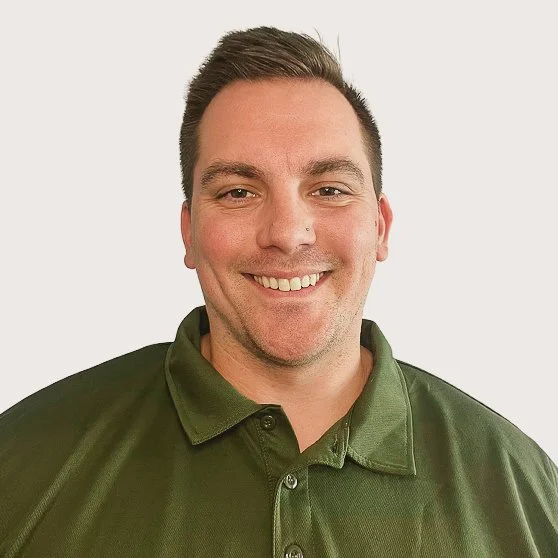Headshot of smiling male tutor with short brown hair.