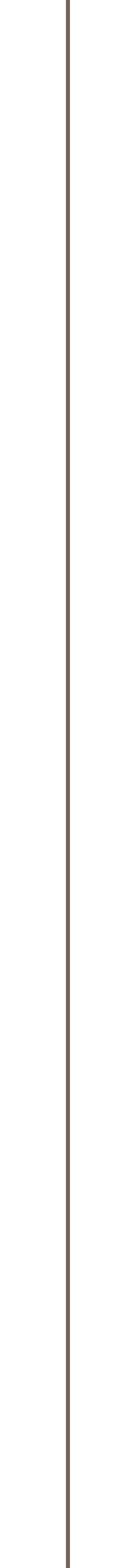 A close-up of a tall, black and gray rocket with a pointed nose cone, standing vertically against a plain background.