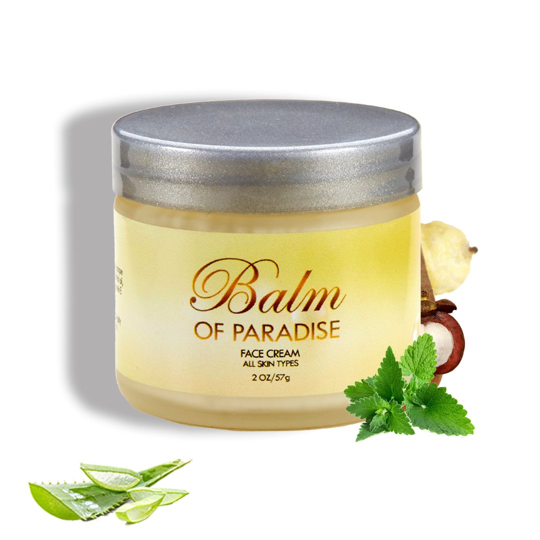 A jar of Balm of Paradise face cream with a silver lid, accompanied by aloe vera leaves, peppermint leaves, and a lemon in the background.