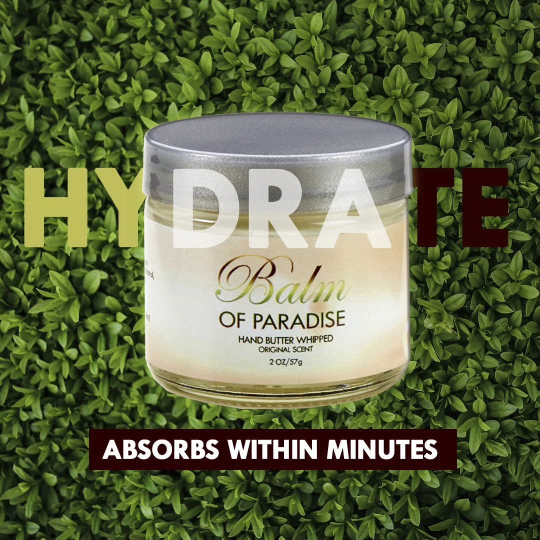 A jar of Balm of Paradise hand butter whiped with a silver lid, set against a background of green foliage. The image has text overlay that reads 'HYDRATE' in large bold letters and 'ABSORBS WITHIN MINUTES' at the bottom.