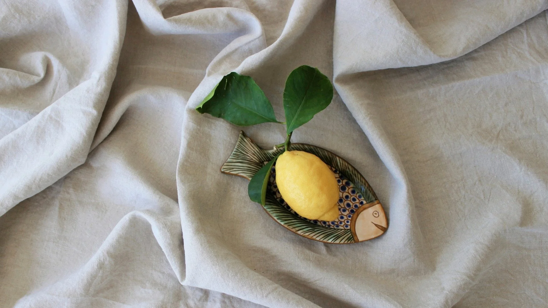 Amalfi-Zitrone in Keramikschale auf Leinentuch (Symbolbild)