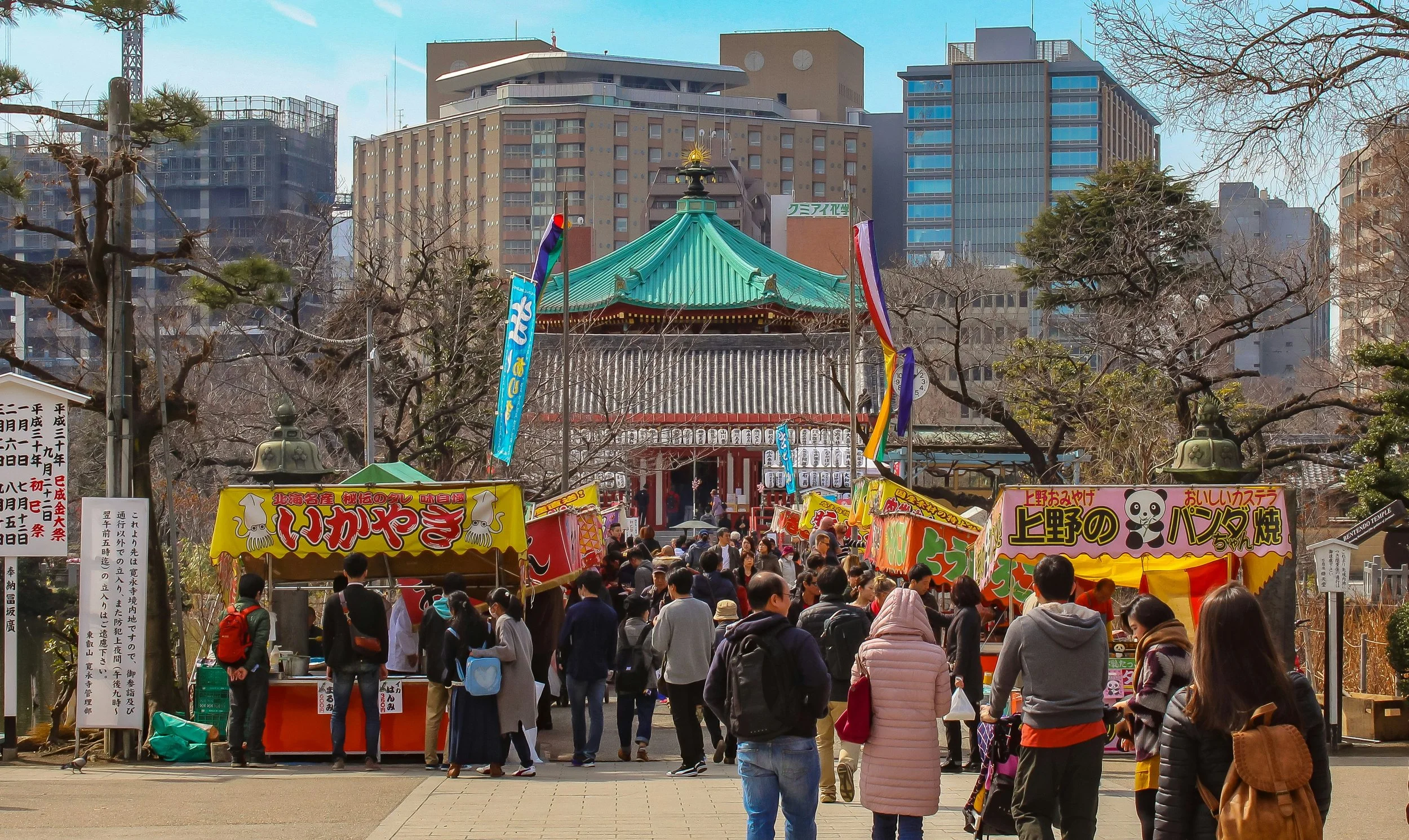 Street food stalls and crowds near Bentendo Temple at Shinobazu Pond in Ueno Park Tokyo