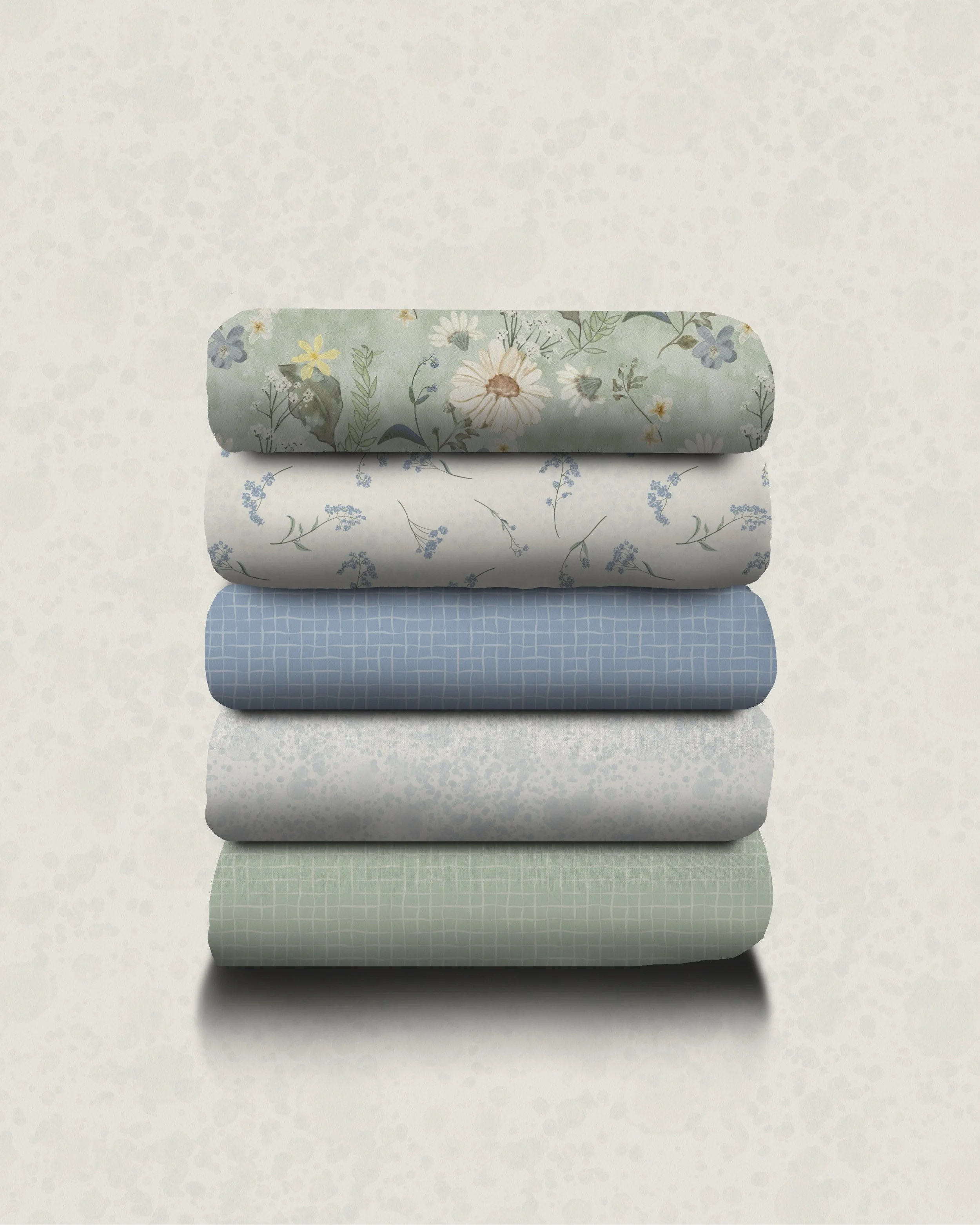 Stack of five folded fabrics with floral and geometric patterns in soft pastel colors against a light, textured background.
