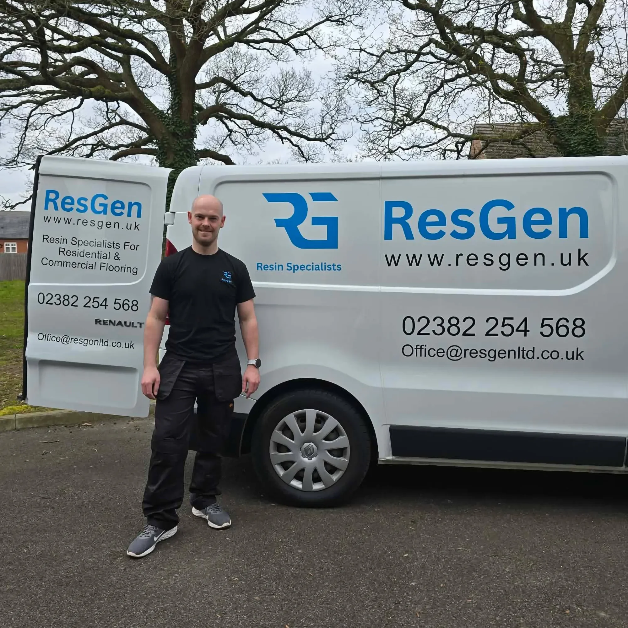 Quill standing next to a white van with blue and black text advertising ResGen, a resin specialist company.