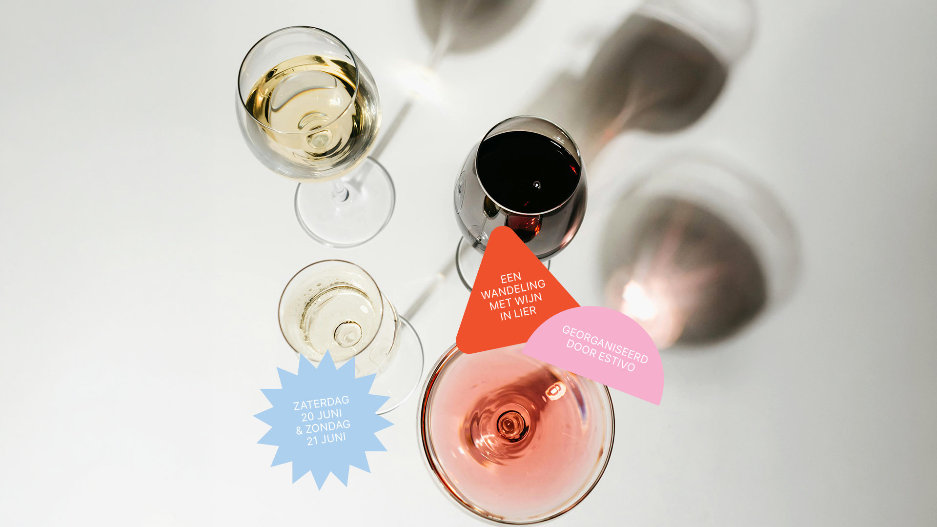 Top-down view of four wine glasses with different types of wine, including white, red, and sparkling, on a white surface with colorful labels and text.