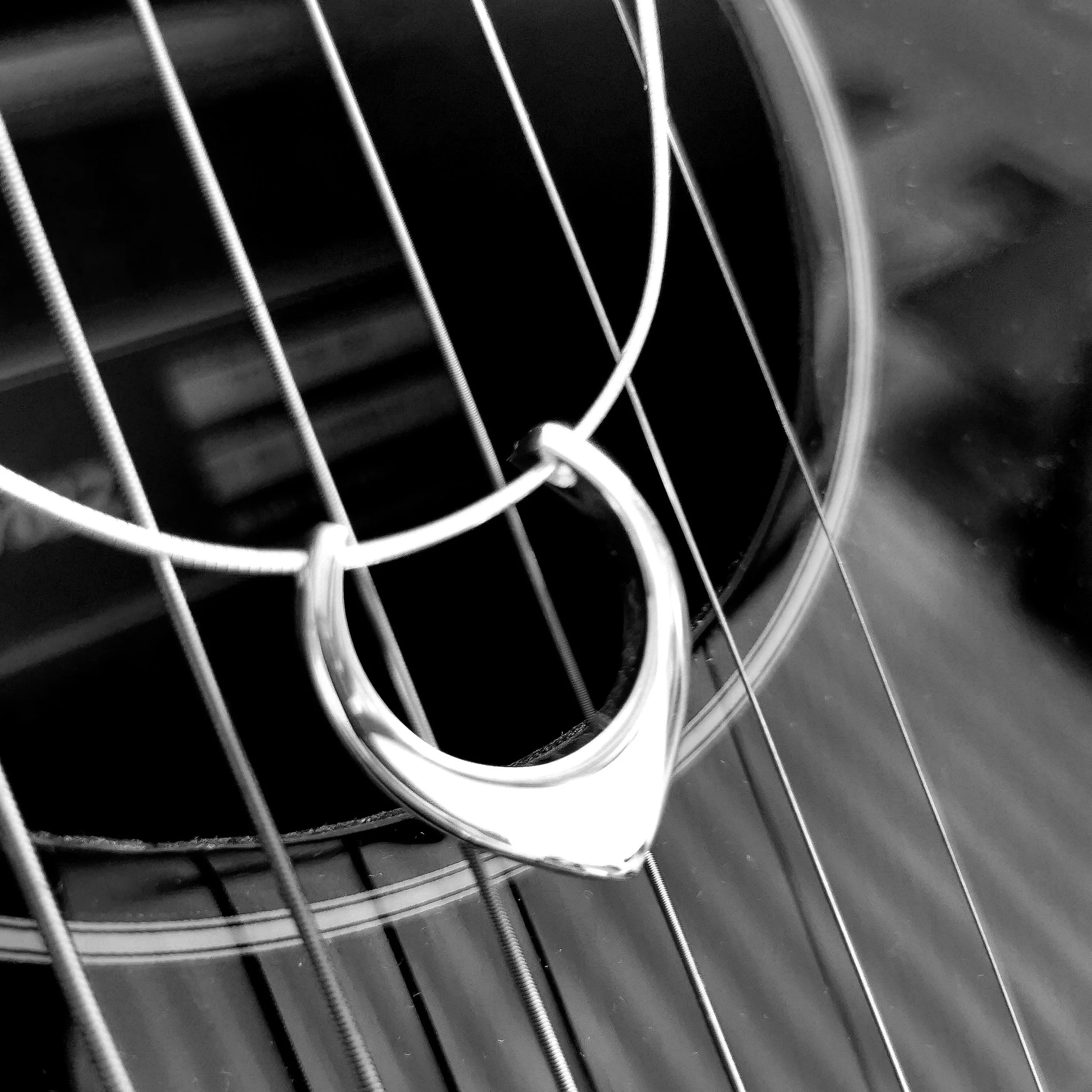 Close-up of a car's front grille with vertical slats and part of a circular emblem.