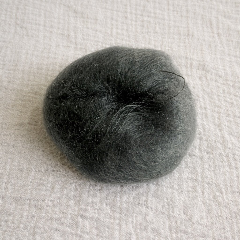 Soft grey mohair yarn on linen.jpeg