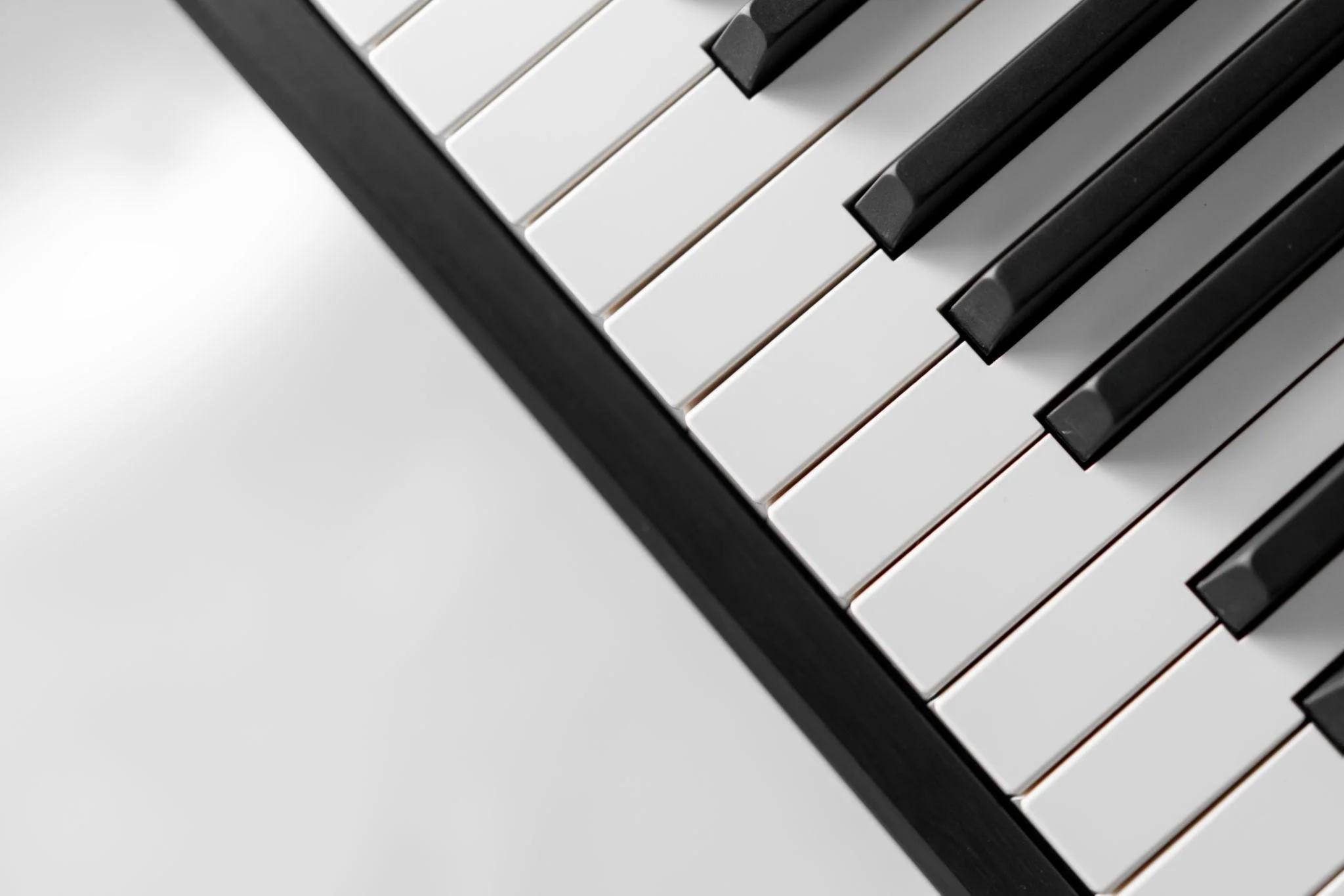 Close-up of piano keys showing white and black keys from a top-down angle.