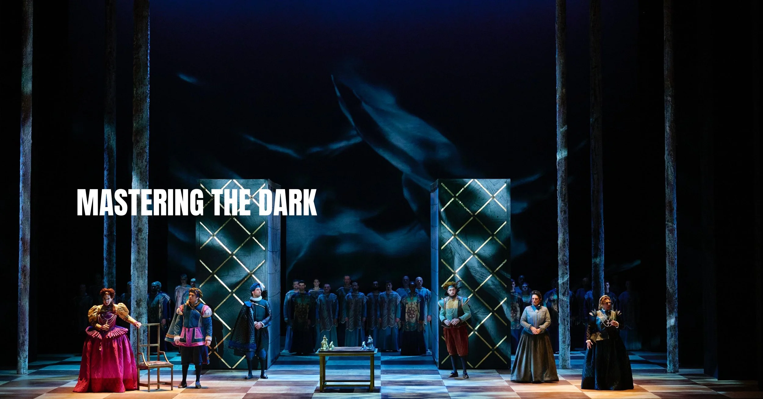 A theatrical stage with a group of performers dressed in historical costumes, set against a dark background with dramatic lighting. The text 'MASTERING THE DARK' is displayed on the left side of the image.