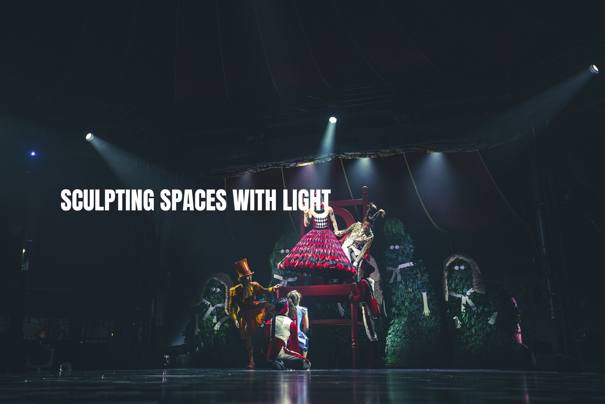 Theatrical stage with performers and props, including a large red frame, mannequins, and green foliage, illuminated by spotlights, with the text 'SCULPTING SPACES WITH LIGHT' overlayed.