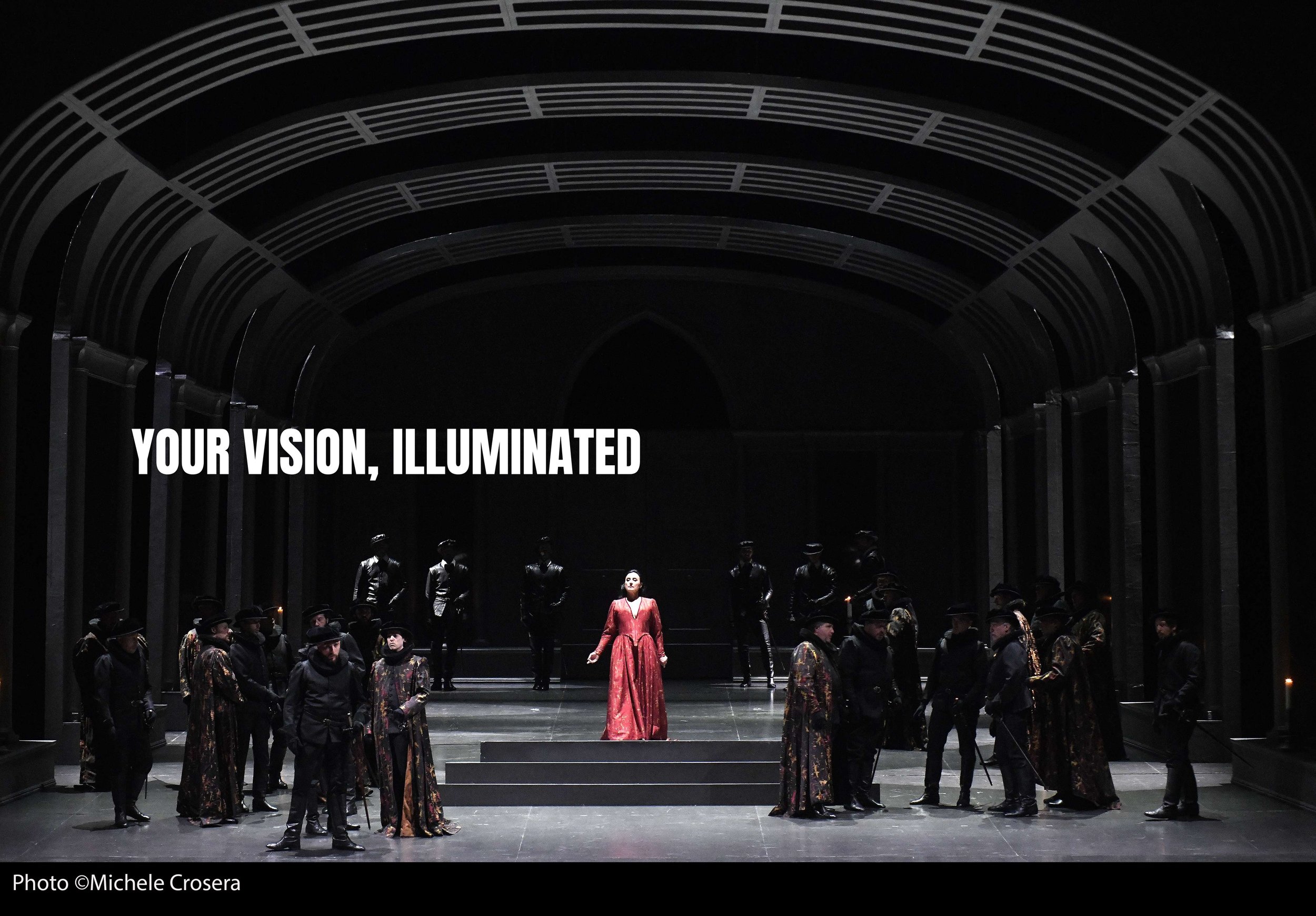 Stage scene from a theatrical production with a woman in a red dress center stage, surrounded by actors in dark costumes, set in a Gothic-style archway. Overlaid text reads "Your vision, illuminated."