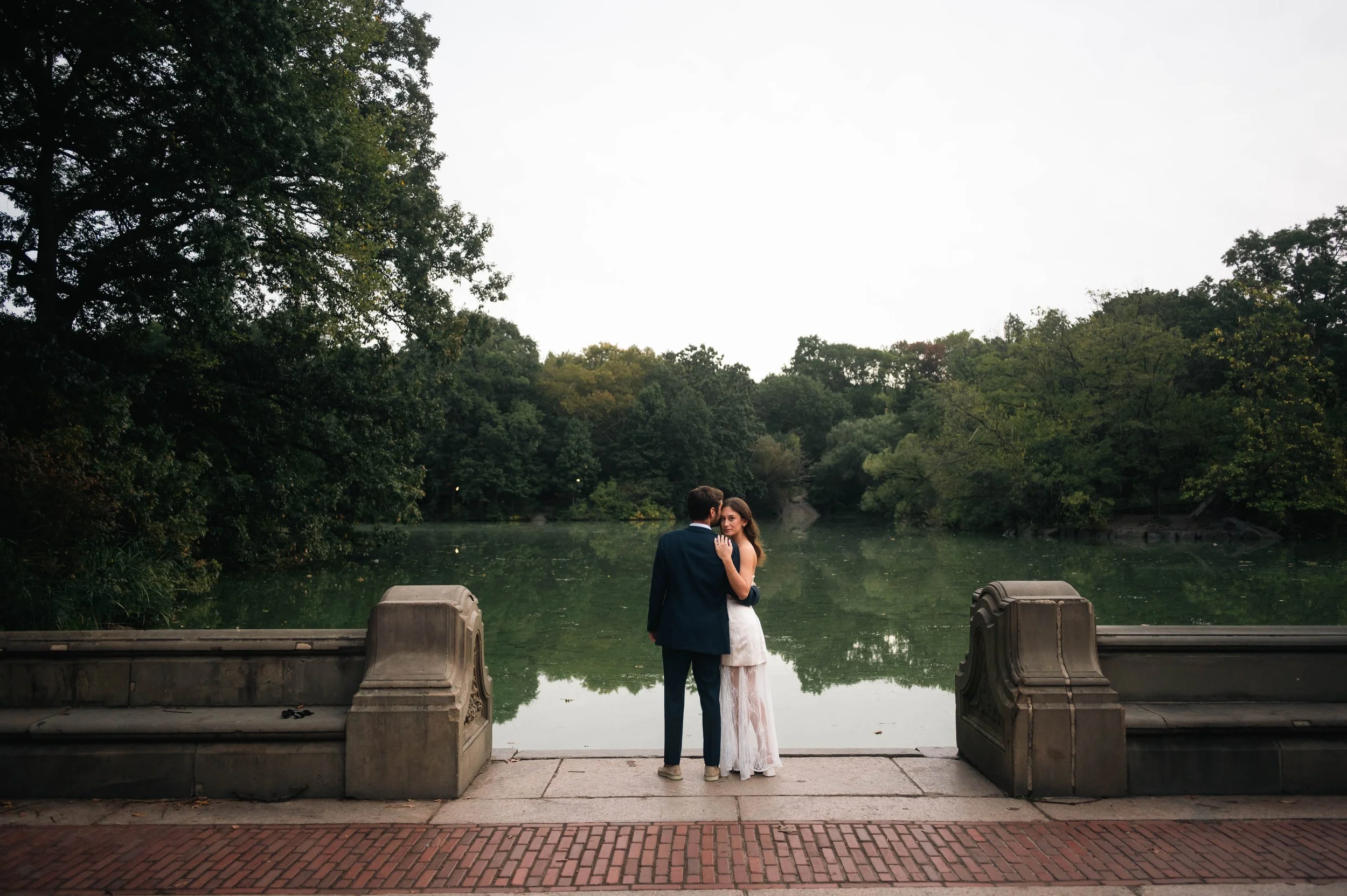 Editorial style engagement photo of a couple at the rowboat pond in Central Park New York City
