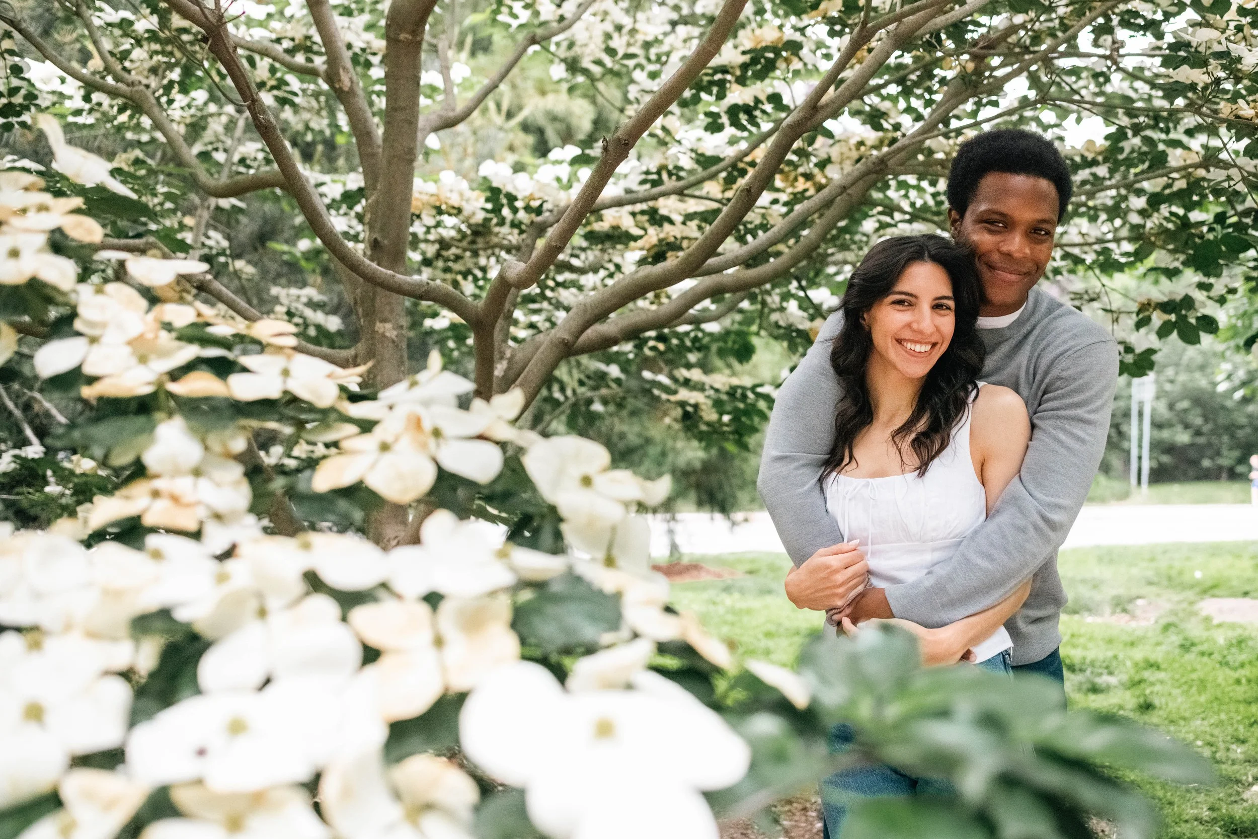 Couple smiling together in Prospect Park during their Brooklyn engagement photoshoot